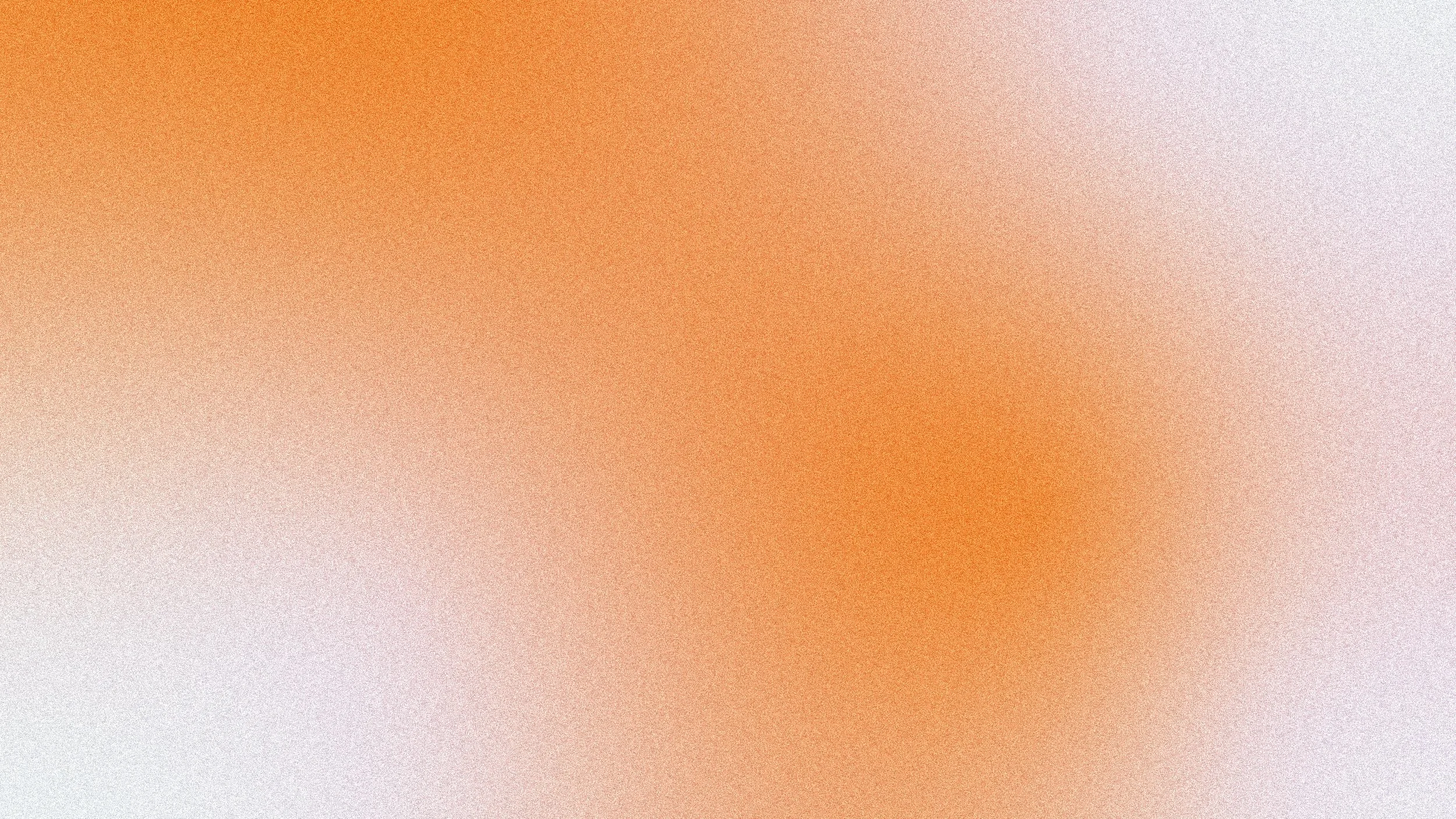 Blurred abstract background with gradient shades of beige, orange, and pink.