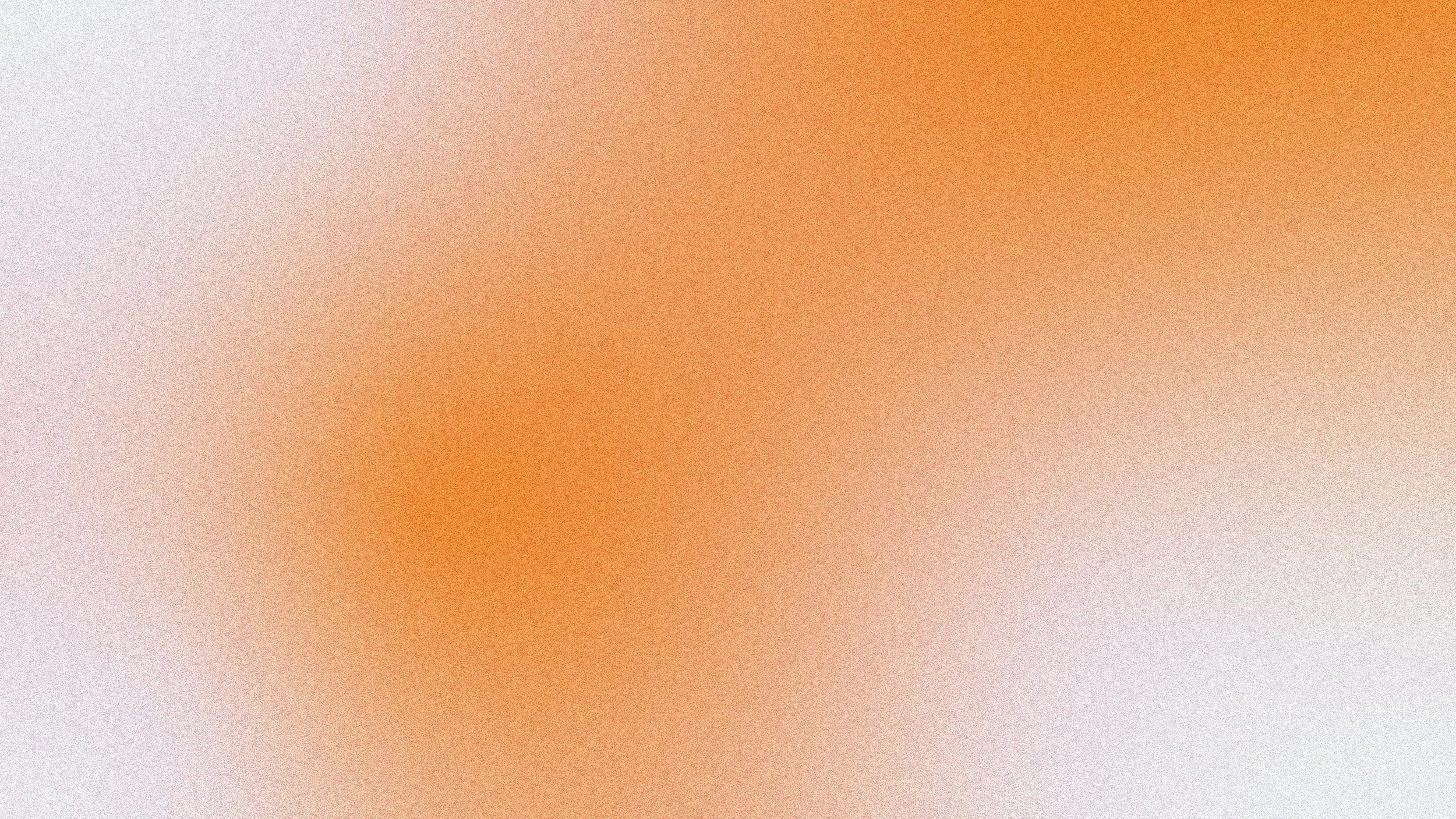 Abstract blurred background with warm orange and white tones.