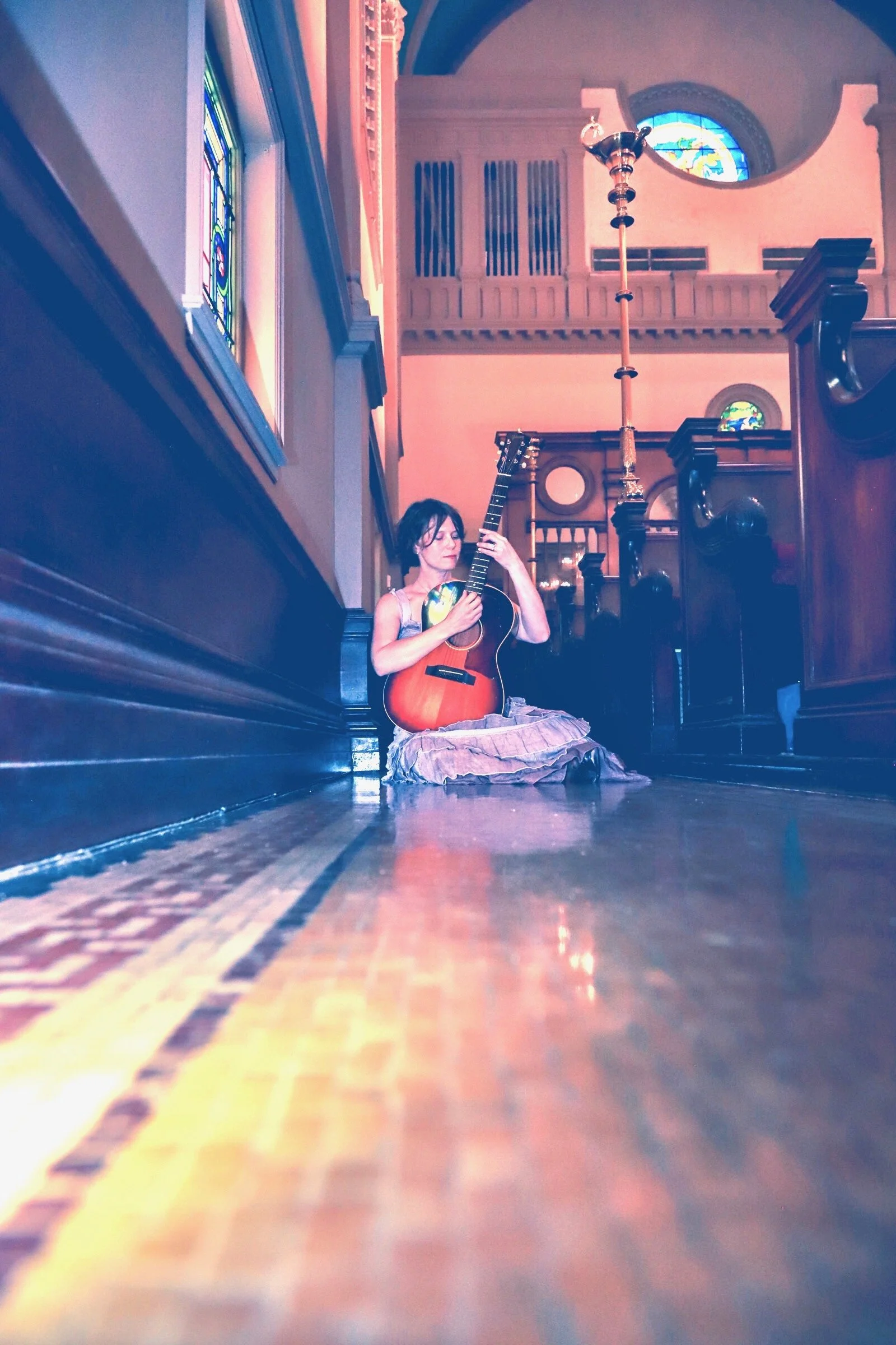 serious with guitar in church.JPEG
