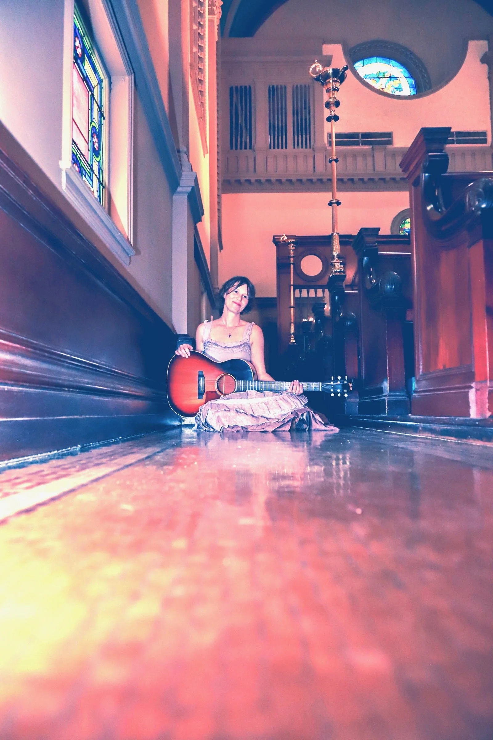 Happy smile with guitar in church.JPEG