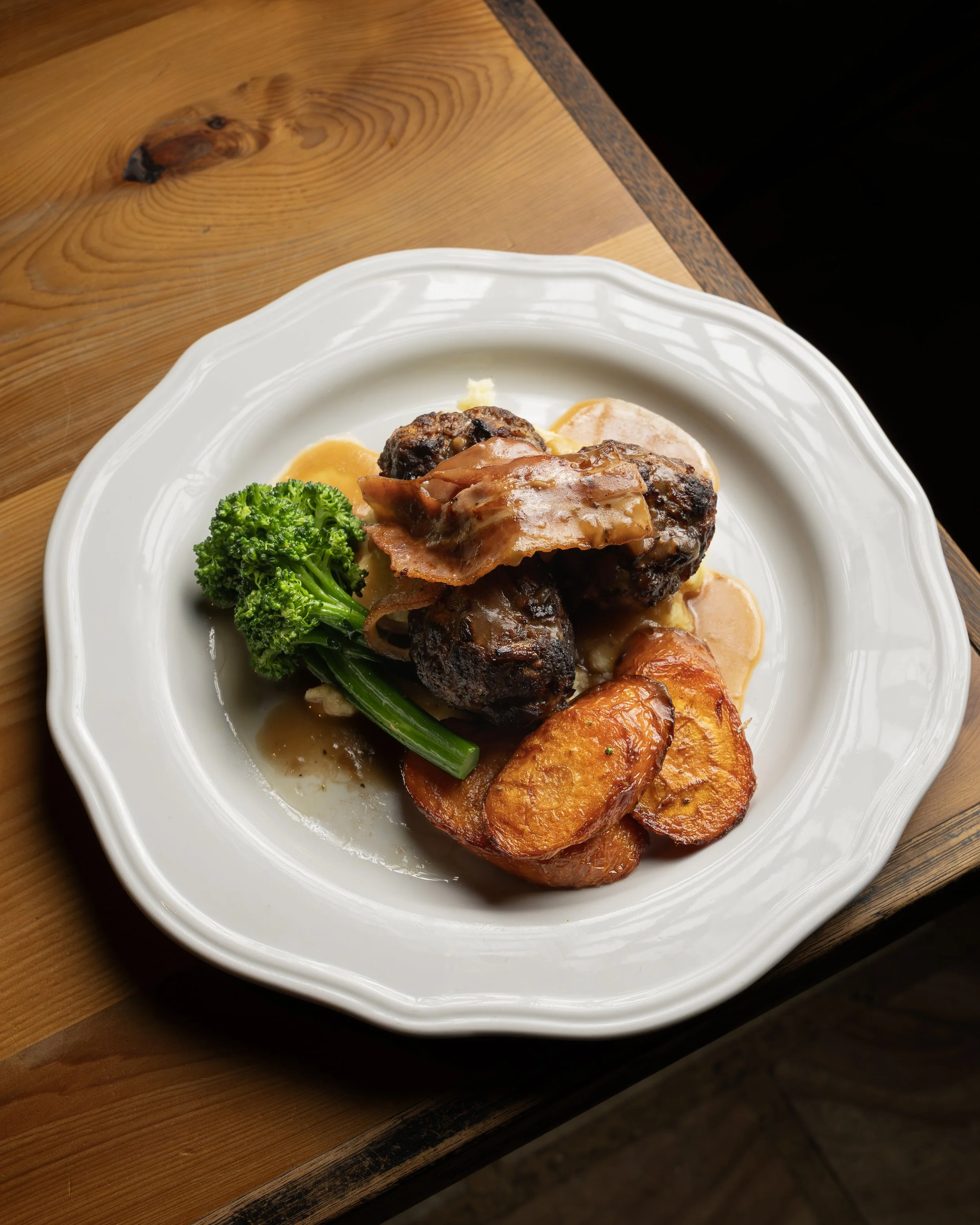 Rockwall's Beef Rissoles  Classic recipe made with premium pasture raised Tasmanian beef, bacon, broccolini, garlic & herb potato mash with caramelised onion gravy (gf)