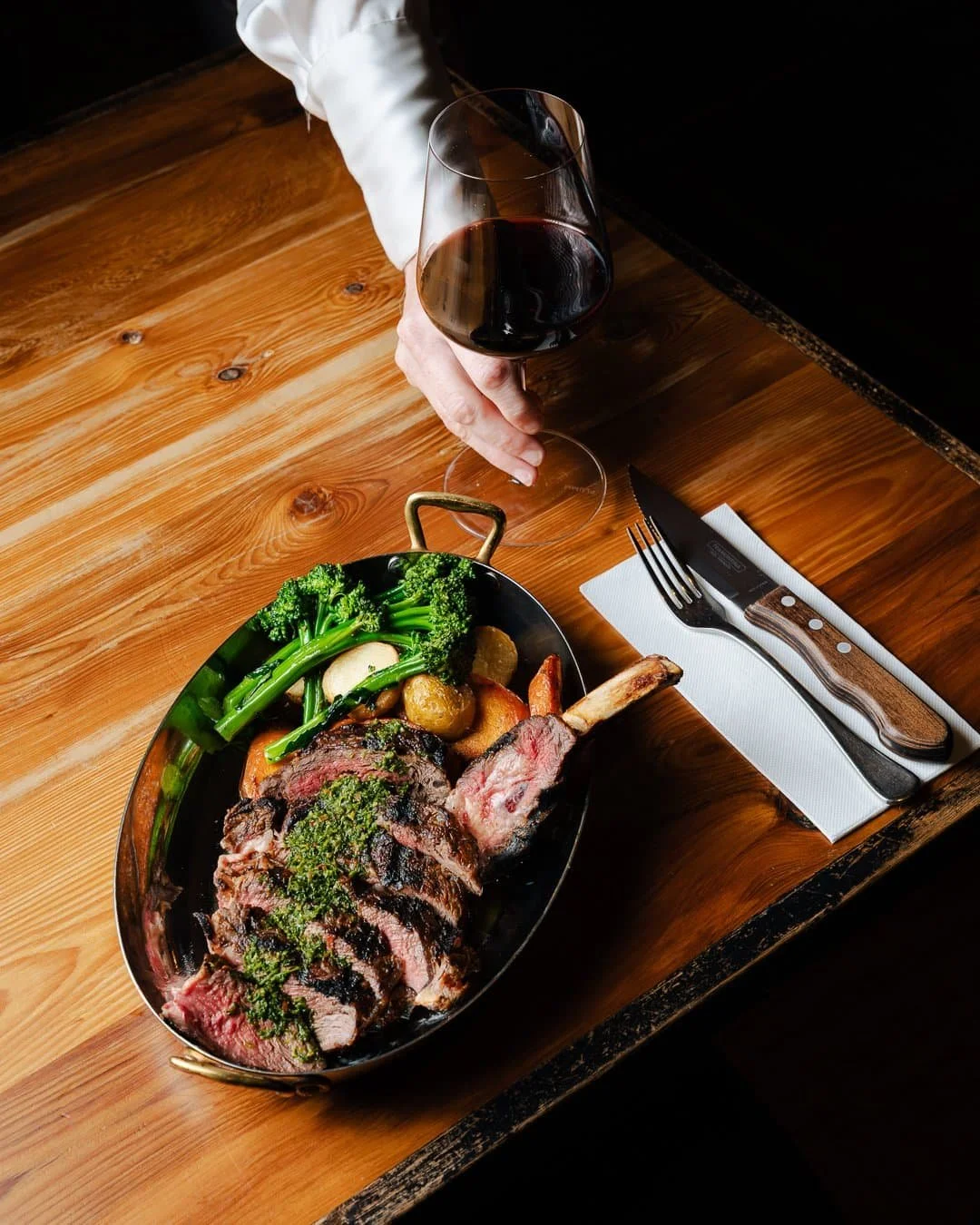 Rockwall's pasture raised Tasmanian rib eye steak served with broccolini, roasted carrots & potato