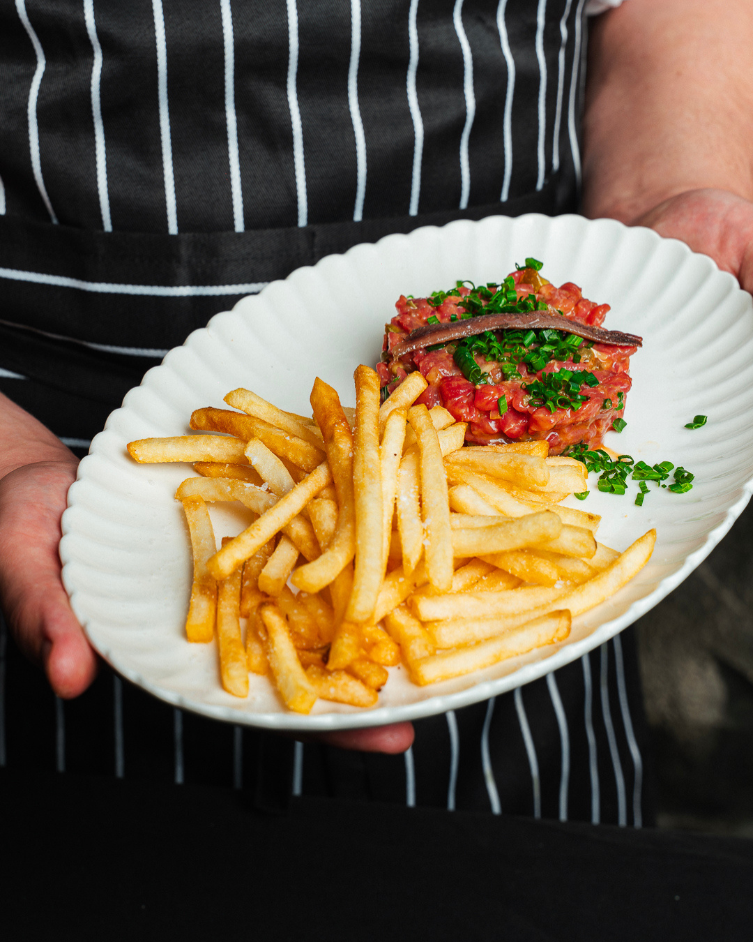 Rockwall Bar and Grill Head Chef Nick Garth presenting pasture raised Tasmanian steak tartare. Recipe Below.