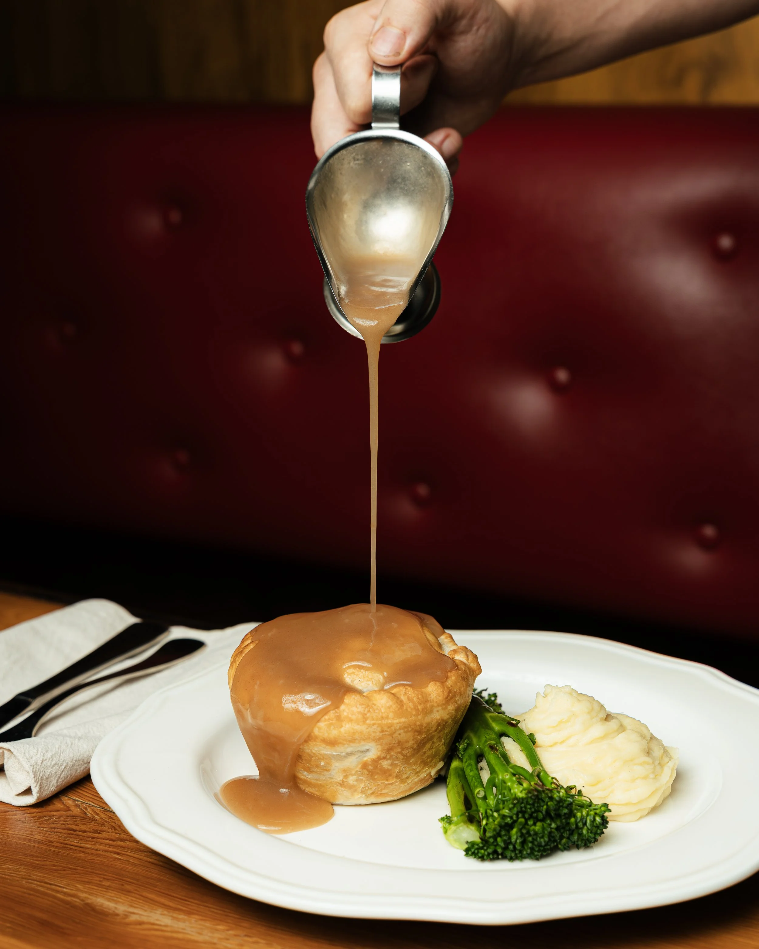 Rockwall's Steak & Guinness Pie Served on garlic & herb potato mash, broccolini with red wine & rosemary sauce