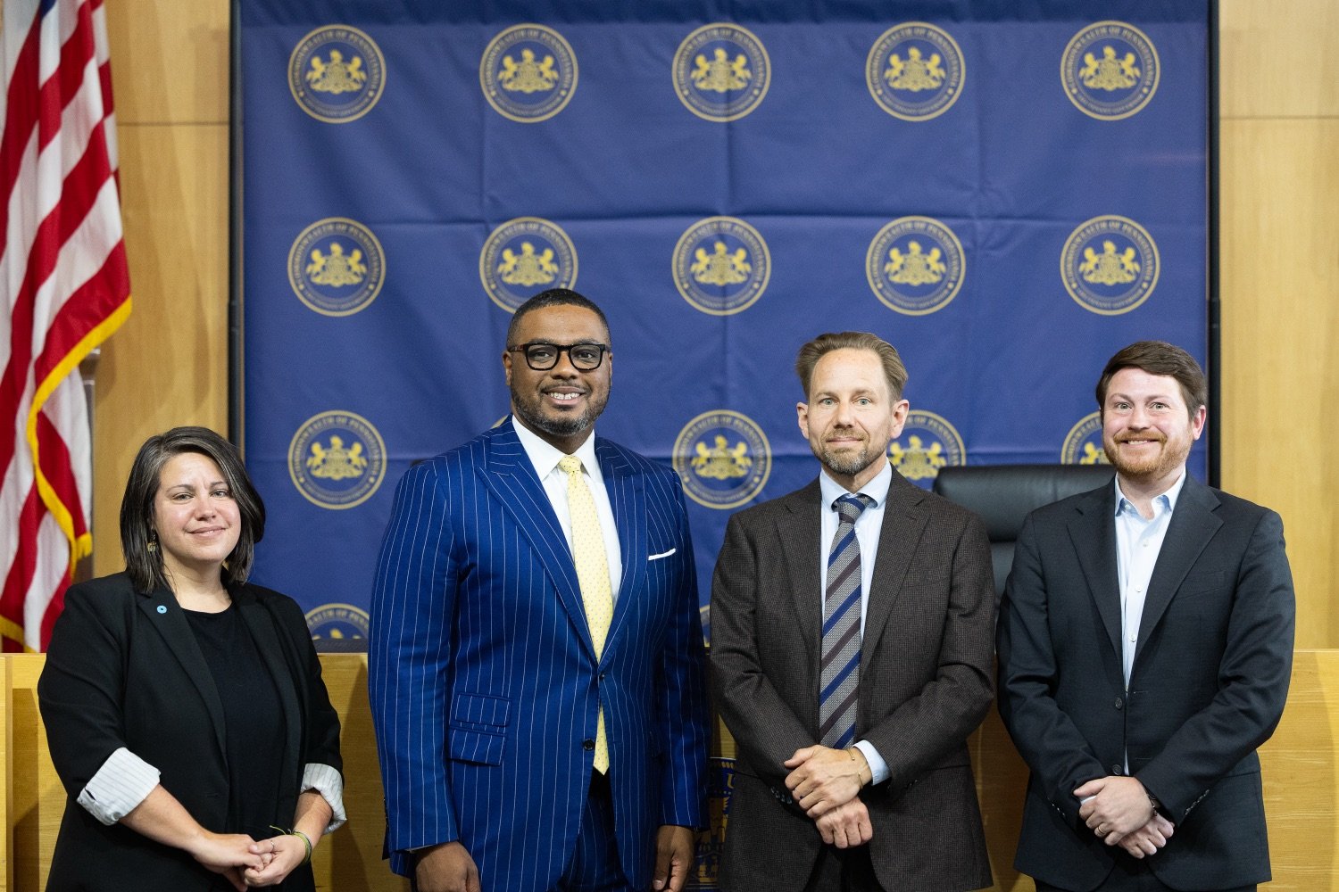 Elizabeth Marx, LG Austin Davis, Mark Szybist, and Robert Routh smile for a photo