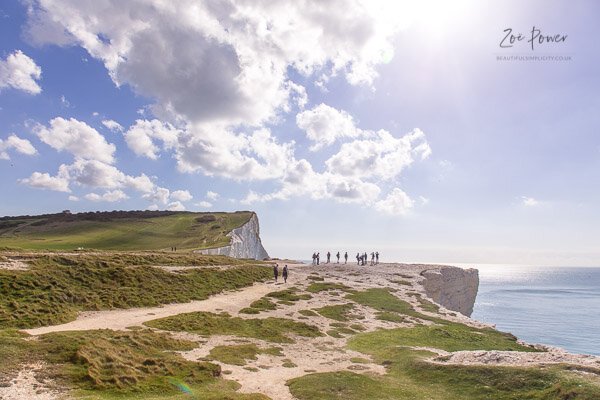 Walkers contemplating the view at Seaford Head, East Sussex, UK 