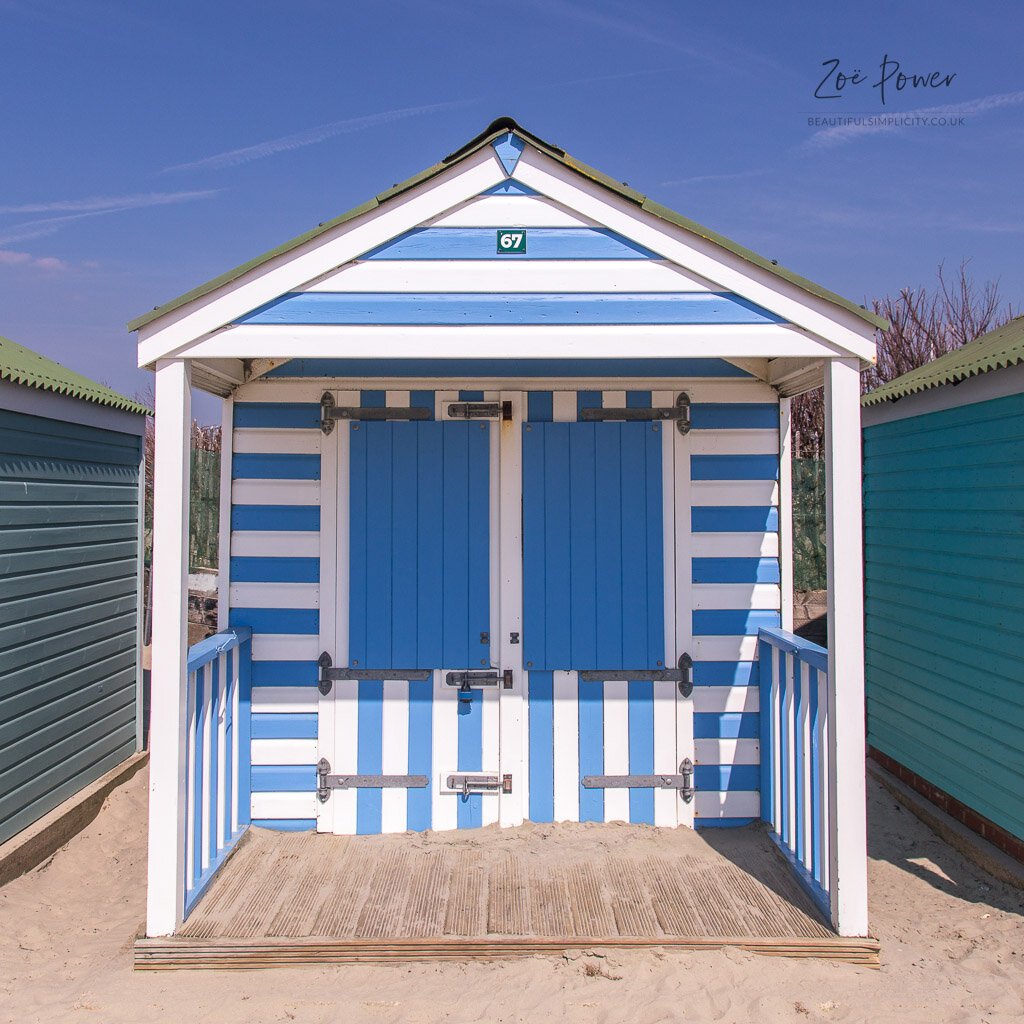 Blue and white stripey beach hut at West Wittering, West Sussex,