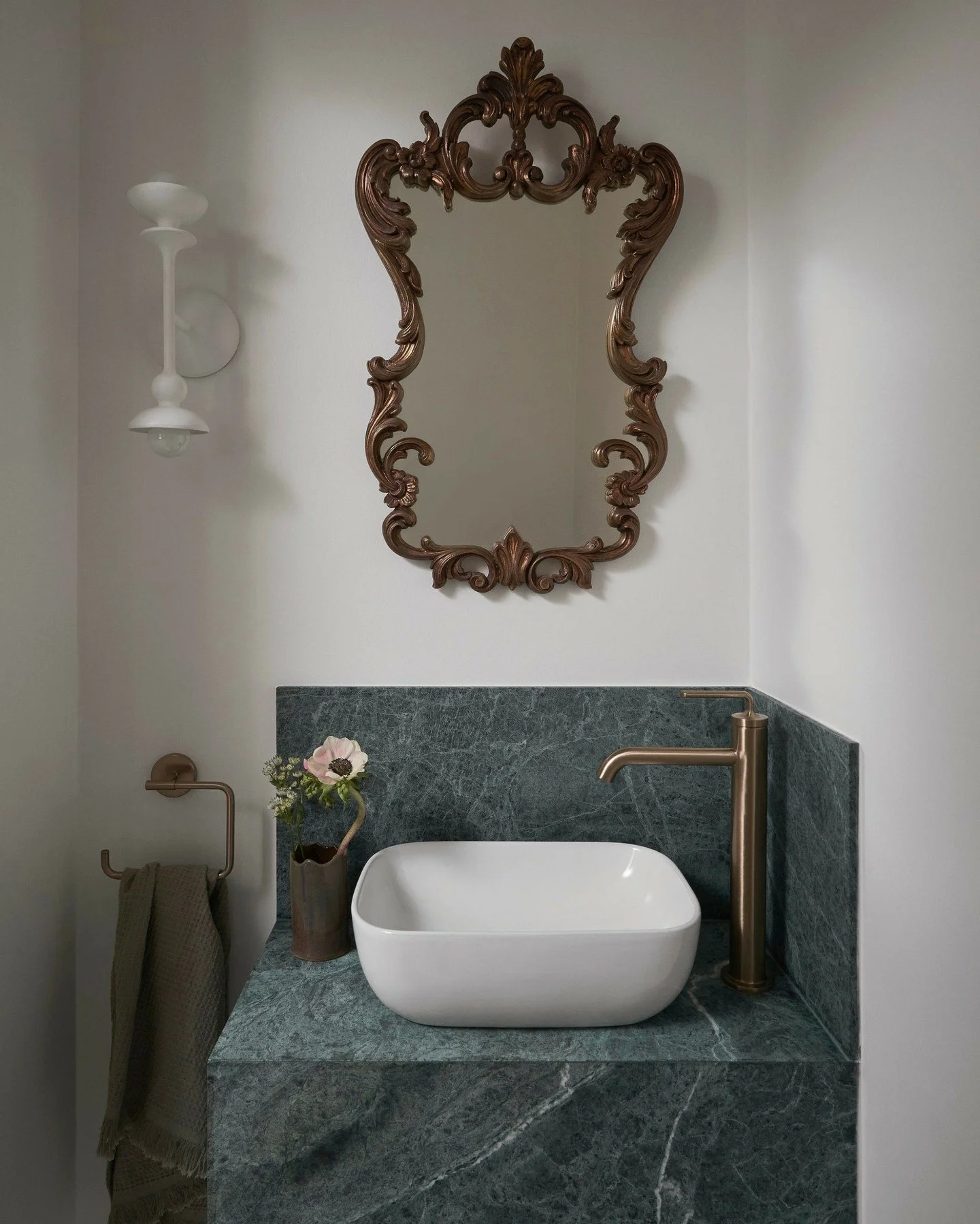 Our powder room design for the Lawrence Park project.
⠀⠀⠀⠀⠀⠀⠀⠀⠀
This compact space provided an opportunity to explore materiality through natural colors. Rather than layering on paint, we let the deep, moody green of Verde Midas marble anchor the pal