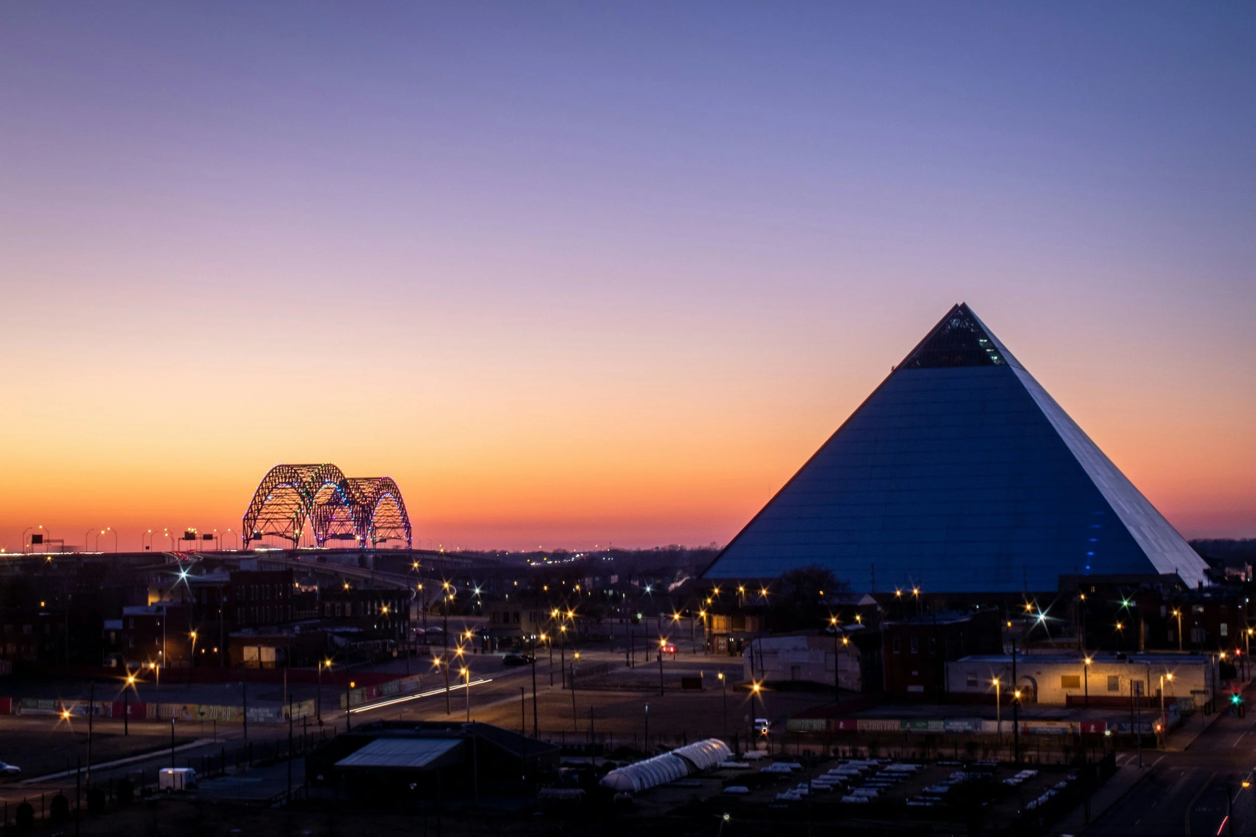 Photo of the Memphis bridge and Bass Pro Pyramid at dusk.