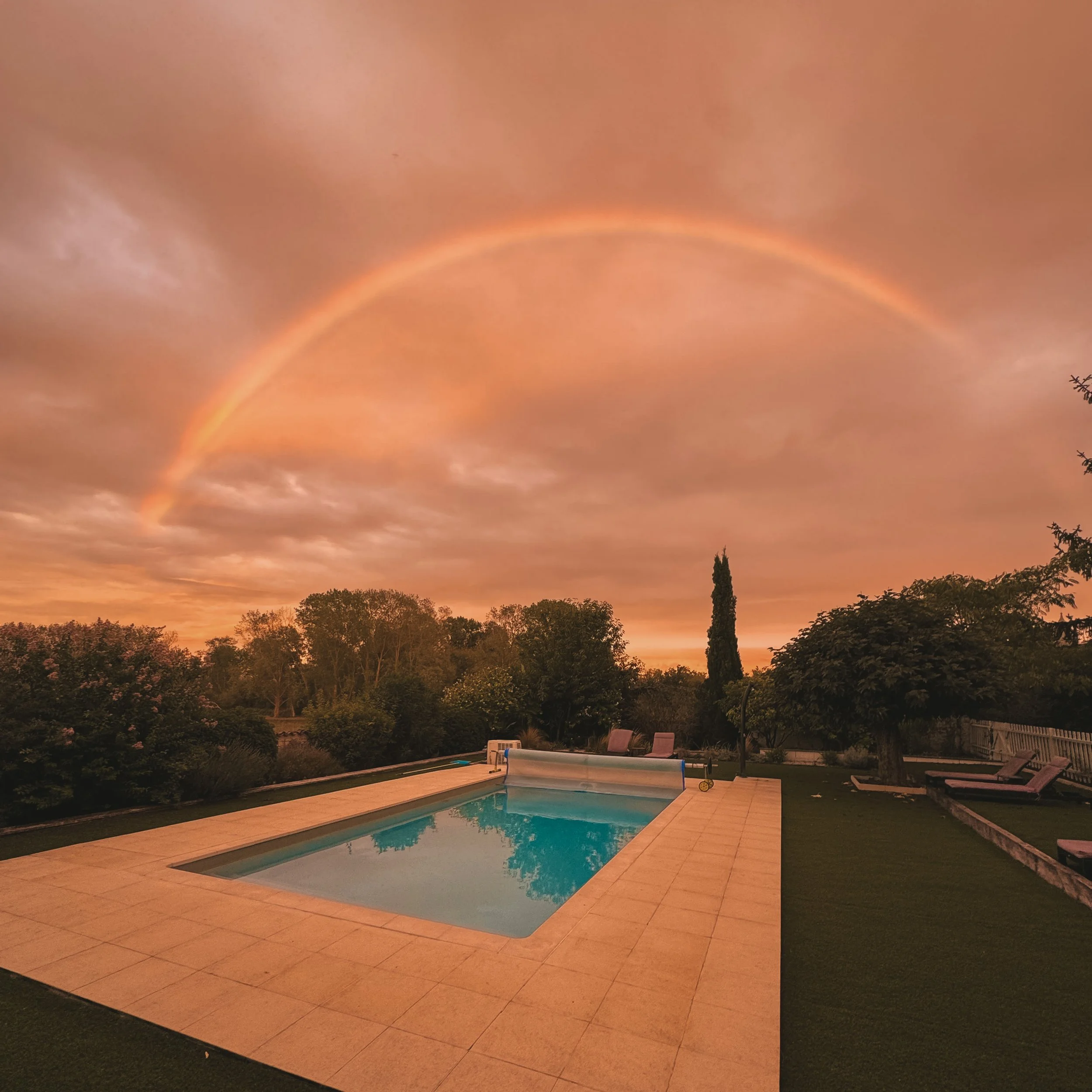 A magical rainbow over the pool at Le Grand Logis