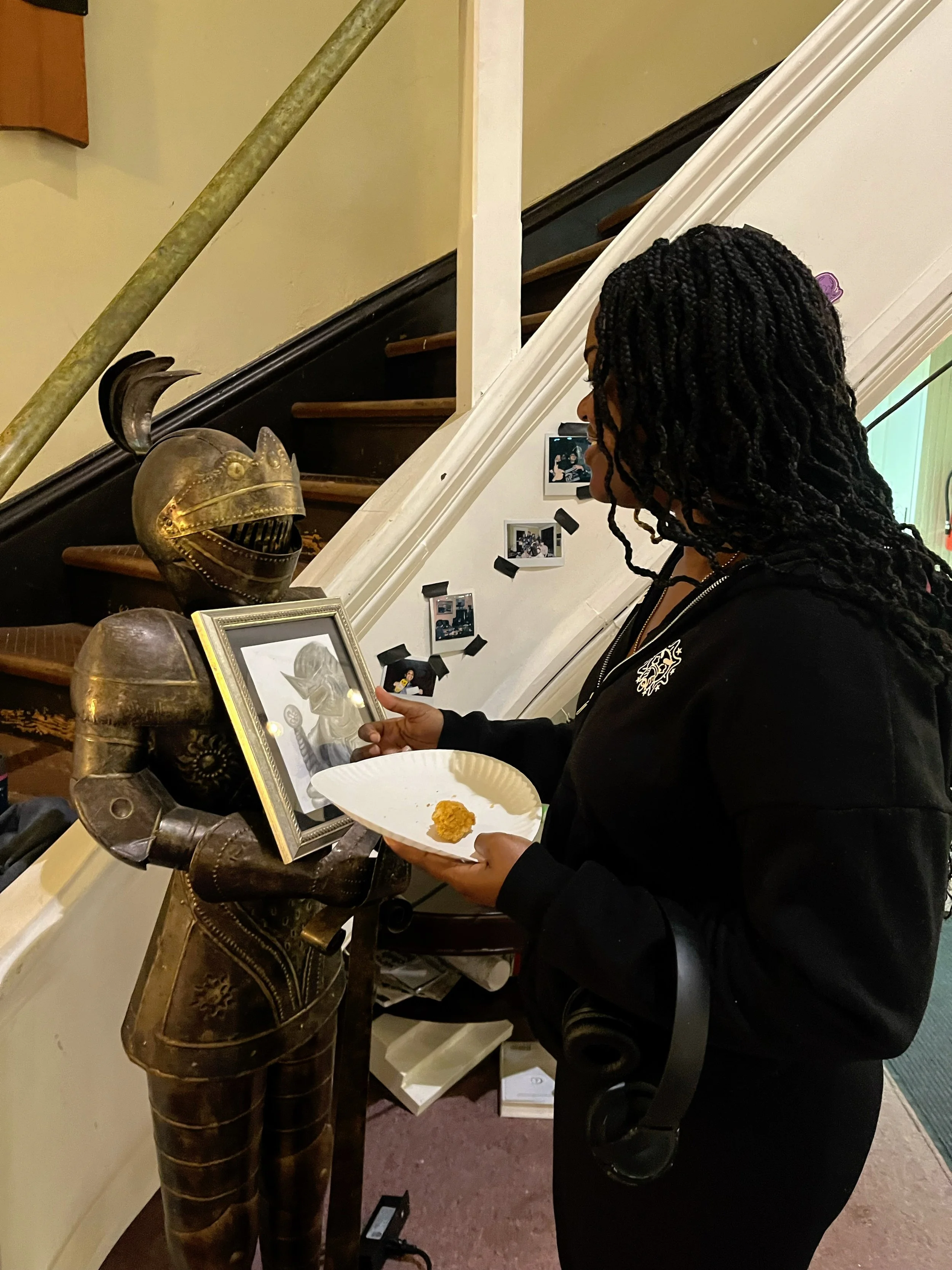   Our Afterschool student admires the artwork we commissioned her to draw for our Halloween outreach  