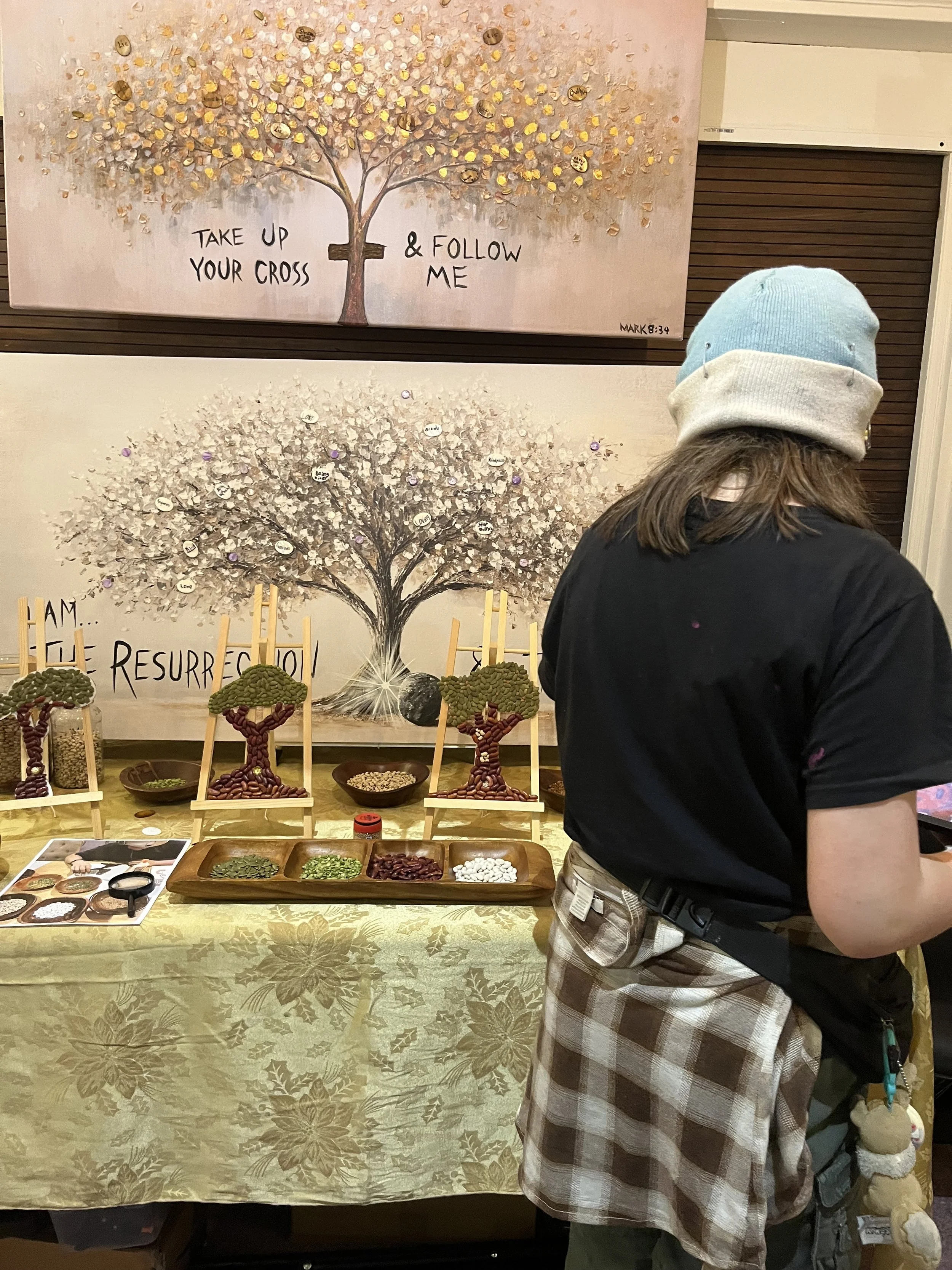   An Afterschool student looks at a group project representing The Parable of the Mustard Seed  