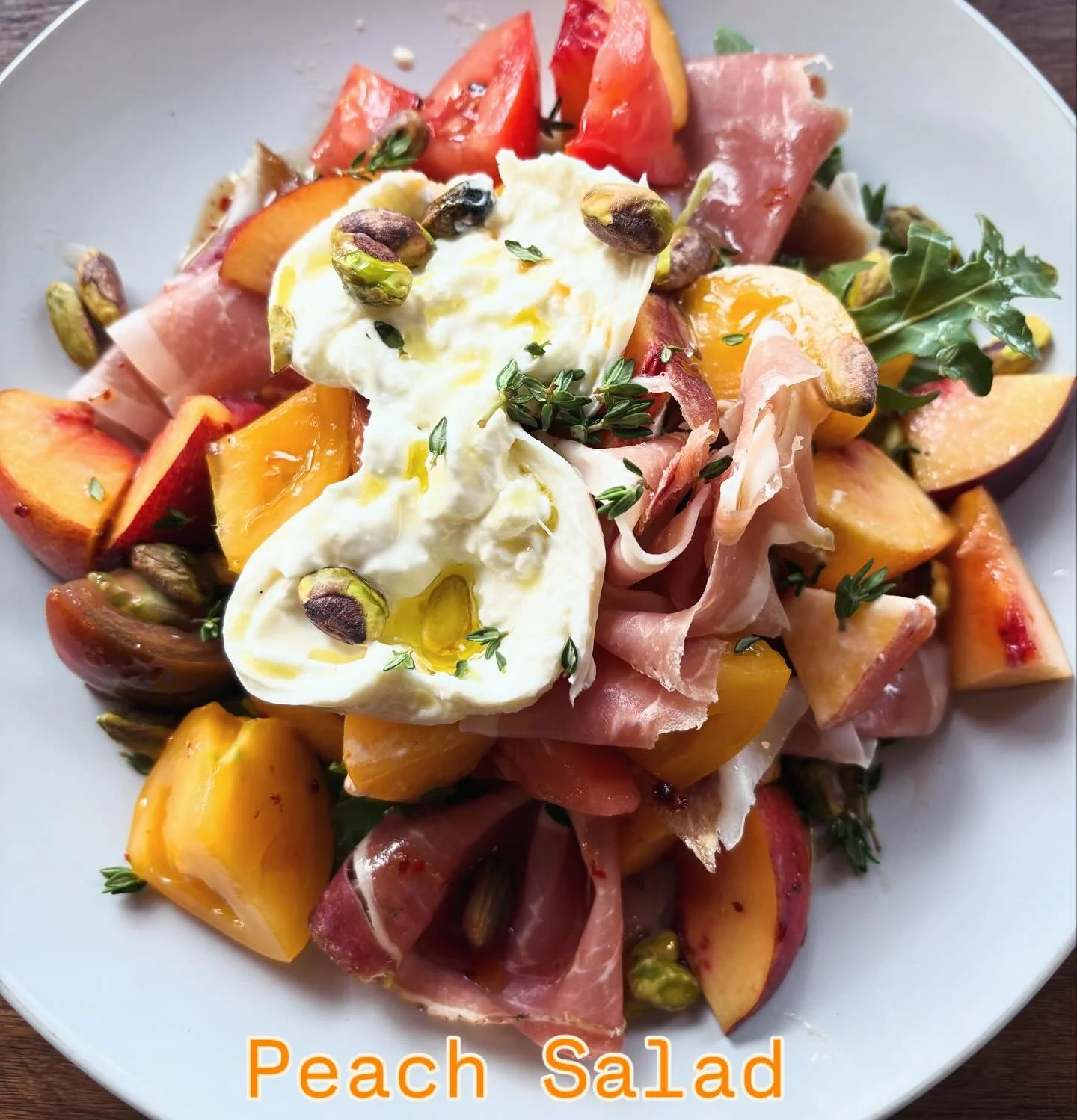 Savor the last days of summer with this delicious Peach Salad! Peaches, heirloom tomatoes, prosciutto, burrata, it&rsquo;s late summer on a plate! Available for the month of September!
