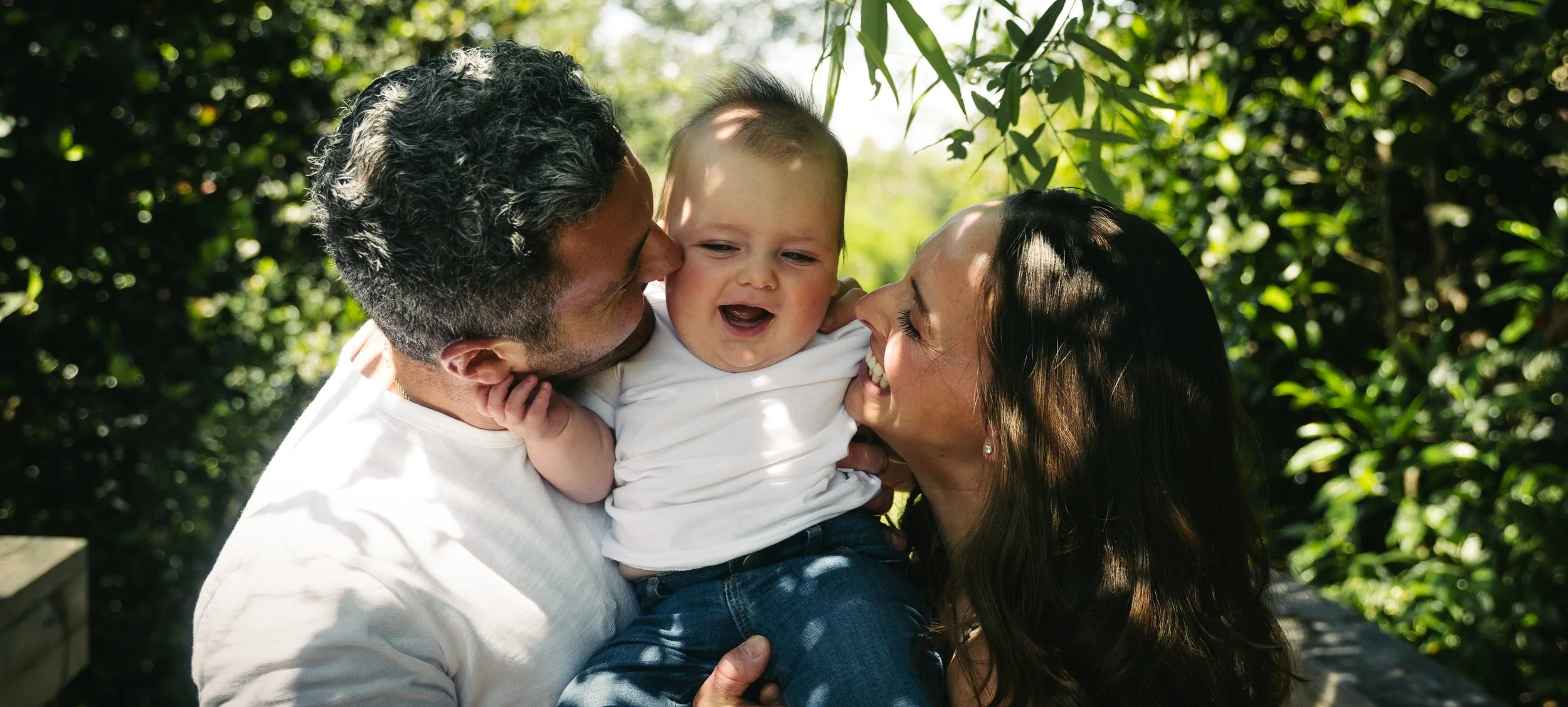 Relaxed outdoor family portraits in Miami with open park scenery.