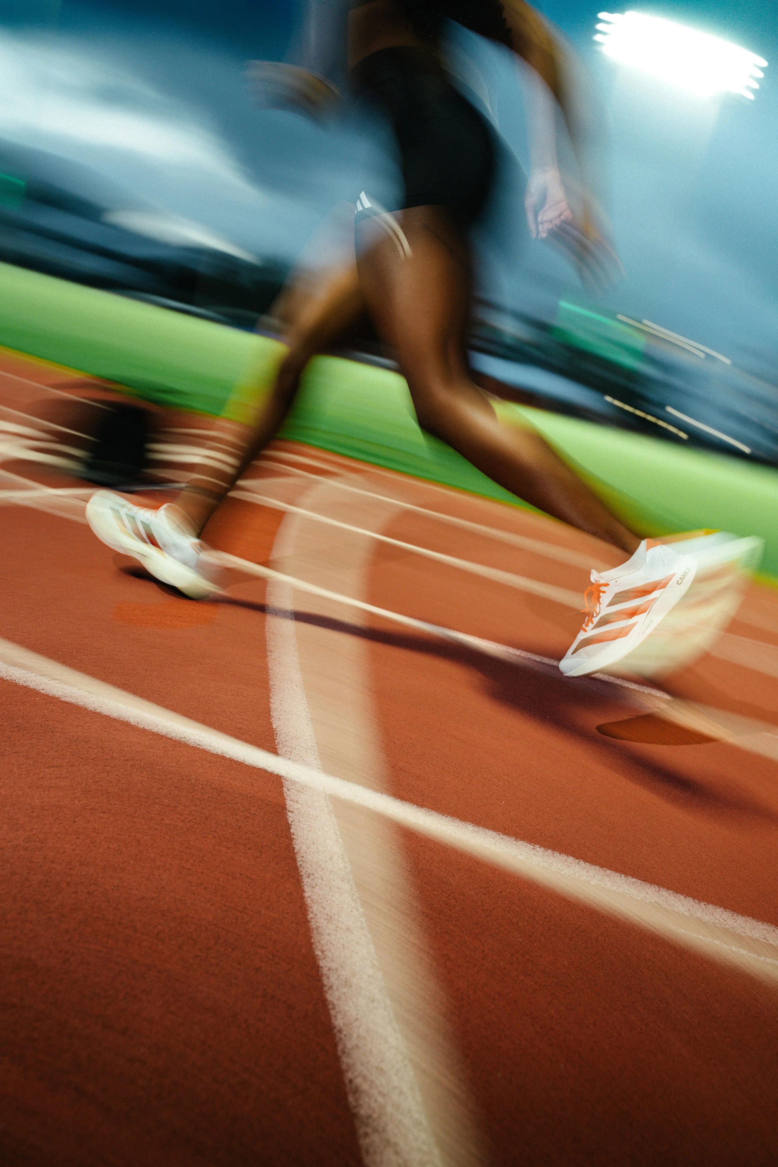 Motion blur of Adidas sneakers in stride across the UM lanes, reflecting South Florida’s rhythm and Adidas’ spirit of innovation.