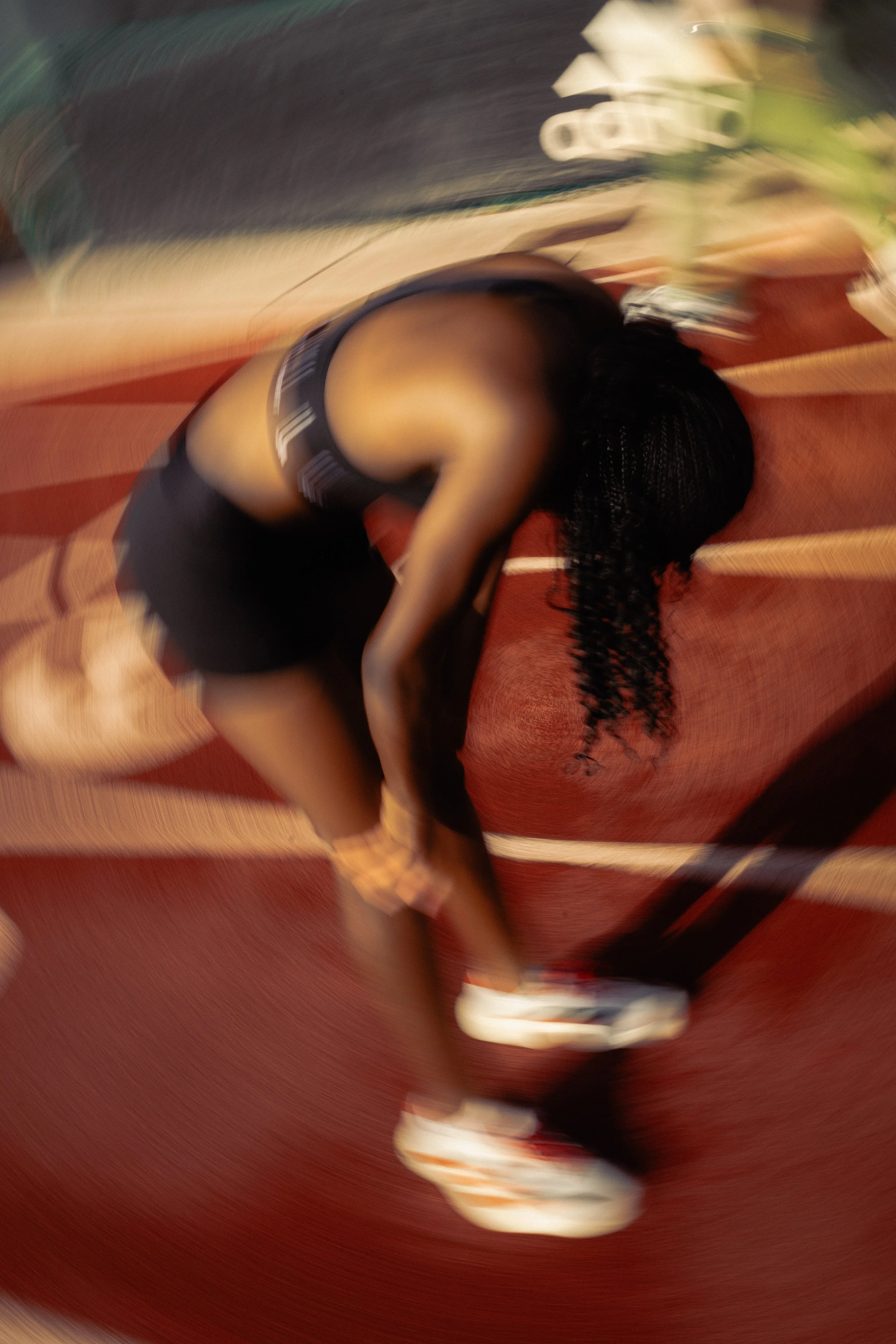 Dynamic motion blur of athlete stretching before a sprint — blending performance energy with cinematic storytelling. Photographed for the Adidas x UM ad spec campaign by Stephen Luttinger Photography.