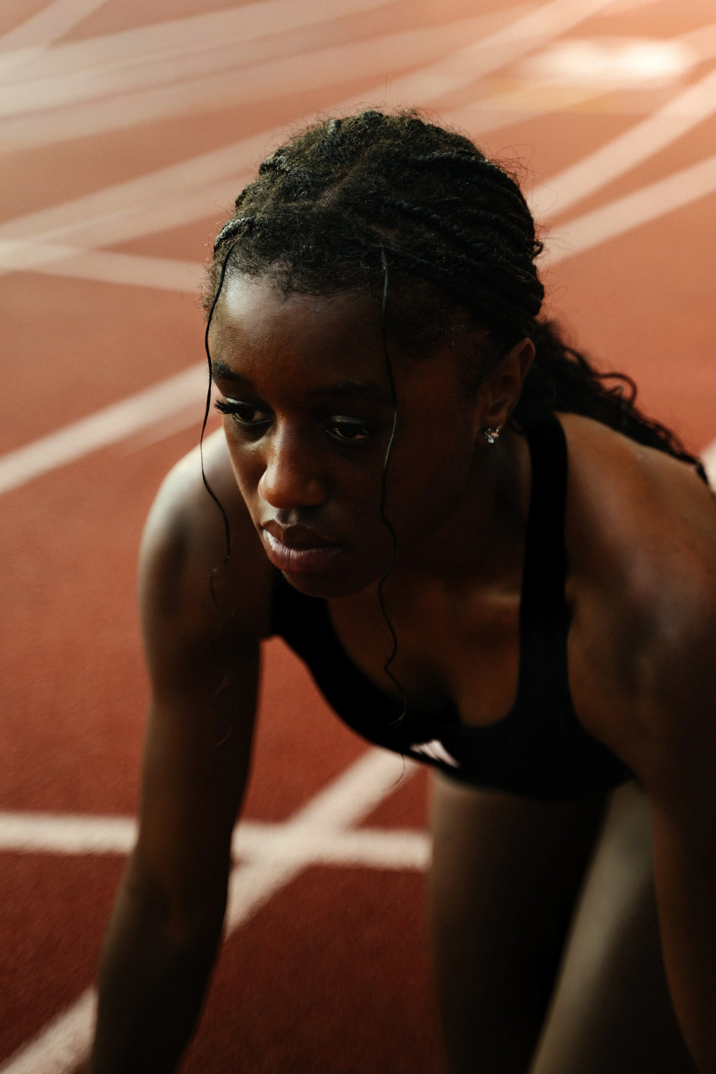 Focused portrait of a University of Miami athlete in Adidas gear, photographed by Stephen Luttinger Photography, emphasizing drive, discipline, and confidence.