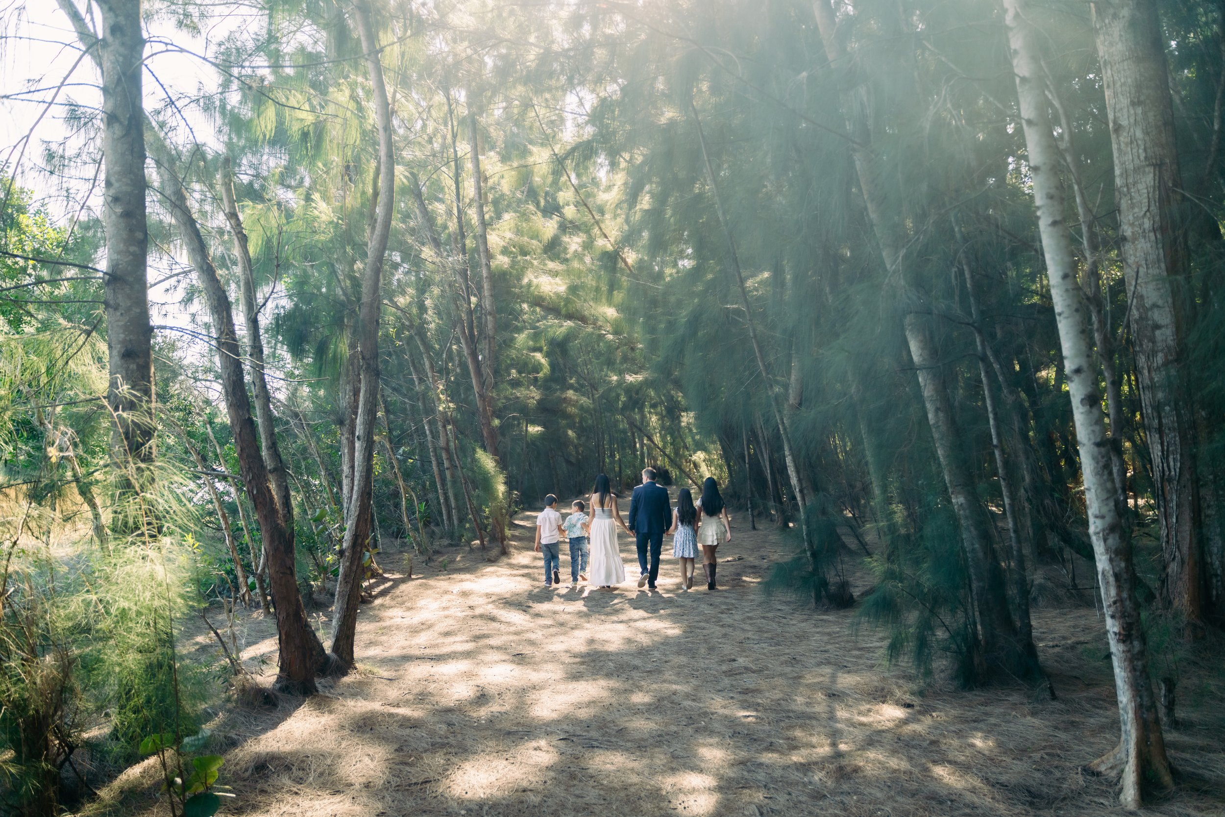 Documentary-style wide shot of a family walking along a wooded path at Markham Park. Natural, storytelling family imagery by Stephen Luttinger Photography.