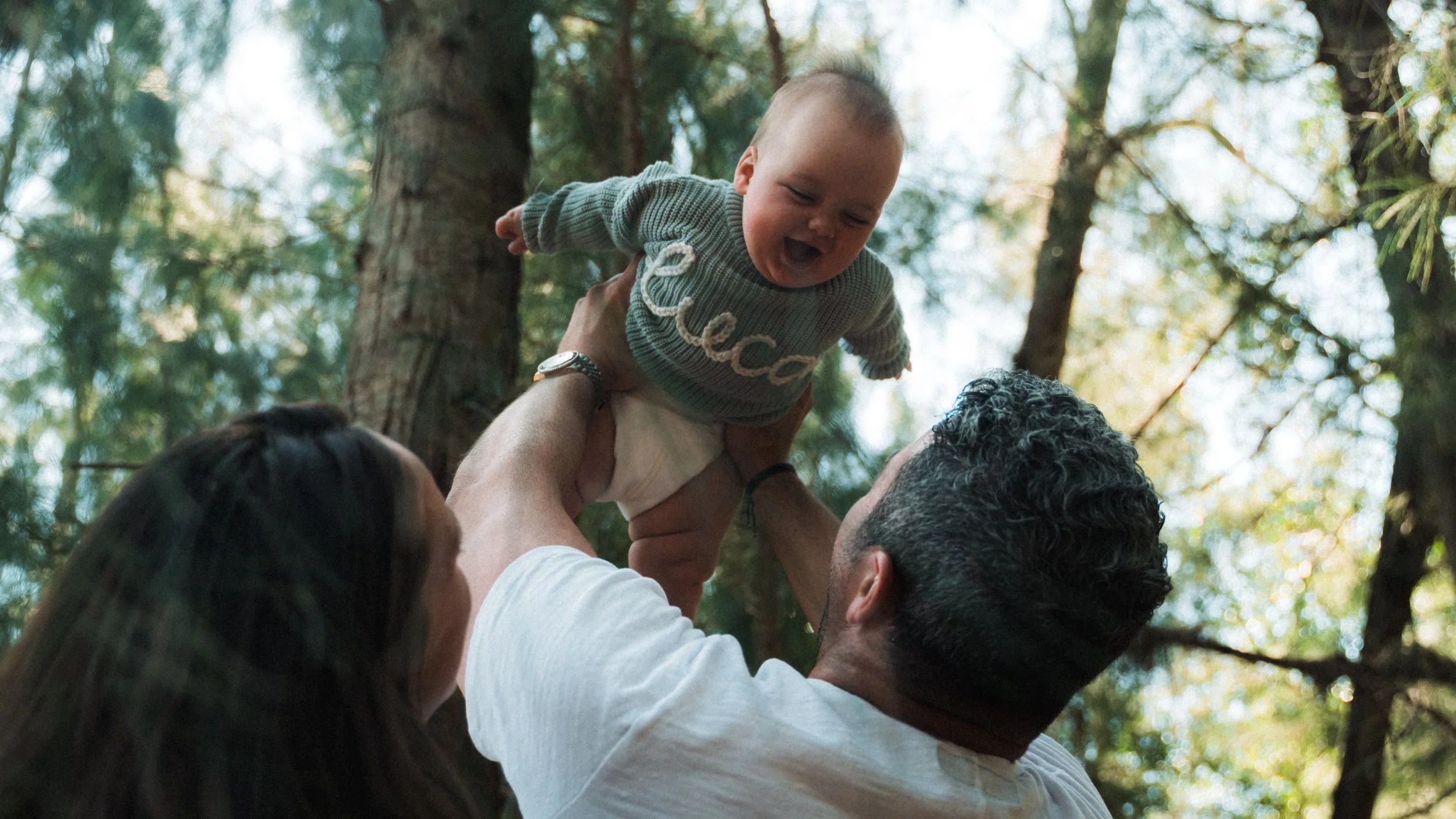 Relaxed outdoor family portraits in Miami with open park scenery.