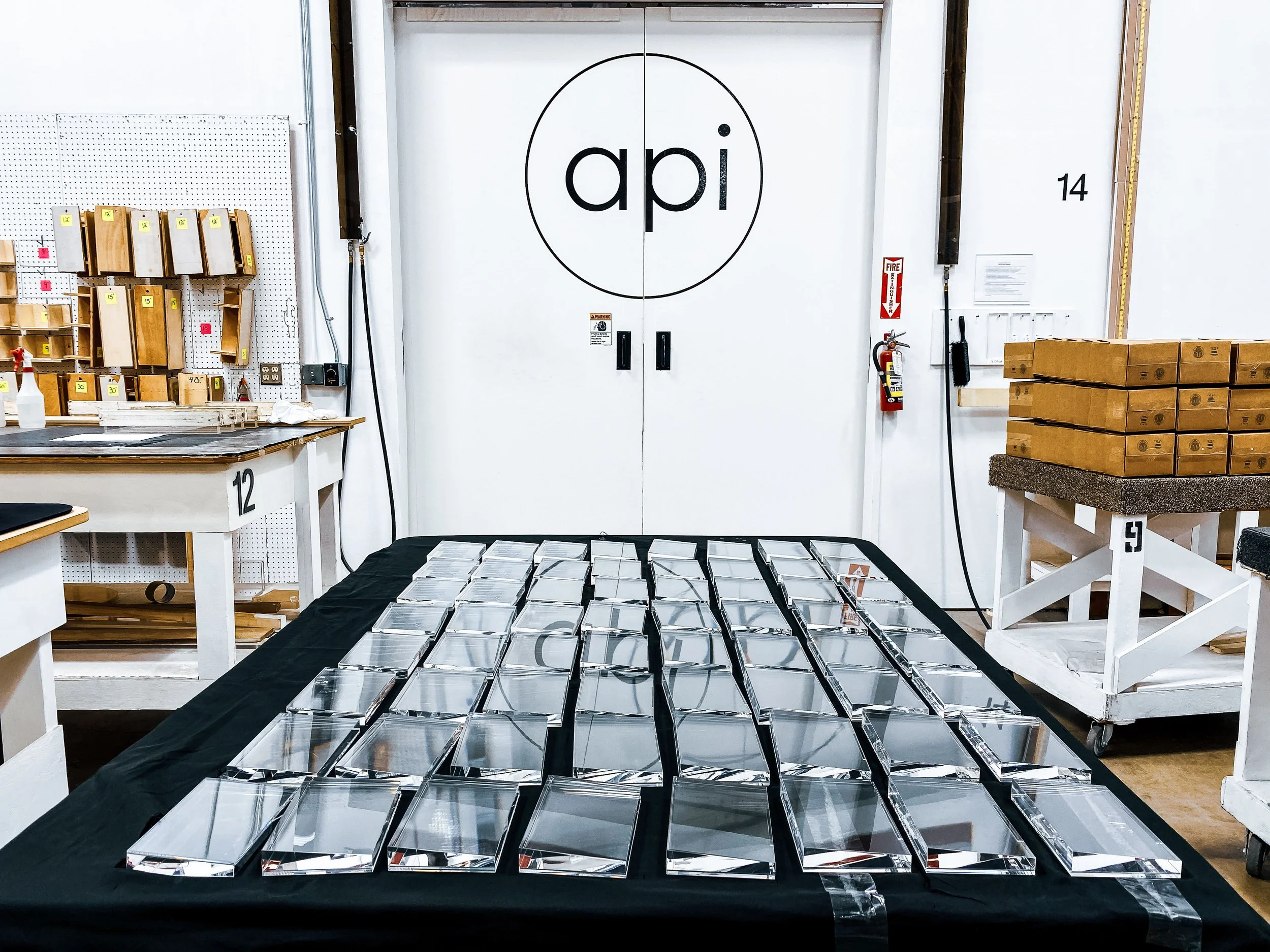 Multiple clear acrylic wedges after polishing awaiting next step in production.