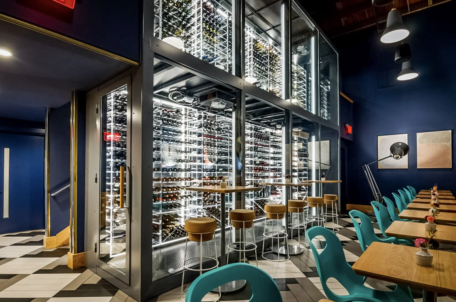 Completed two story acrylic wine cellar with led lighting in a metal and glass enclosure.