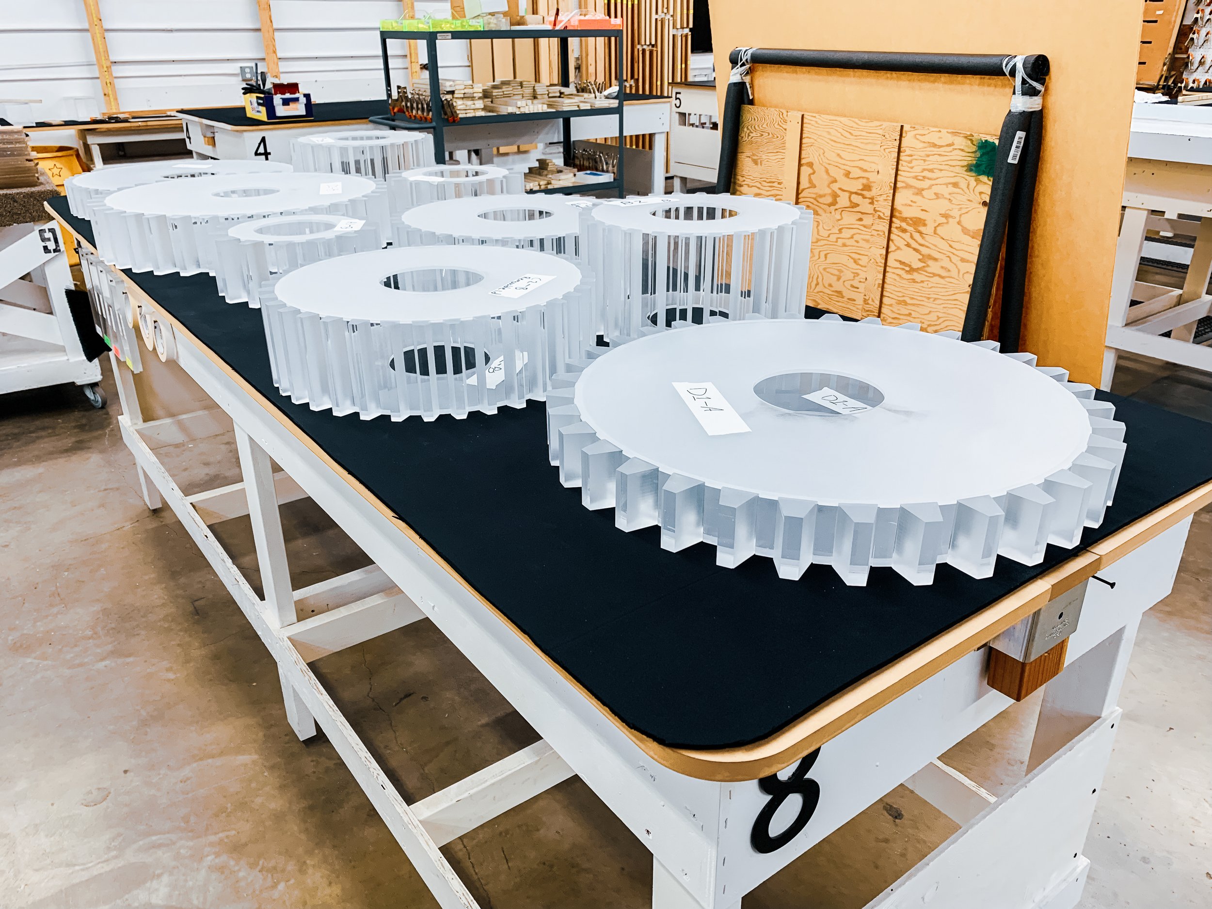 Complex acrylic geometries with frosted 3D gears and tapered blocks bonded to acrylic cylinders, requiring precise alignment and seam control.