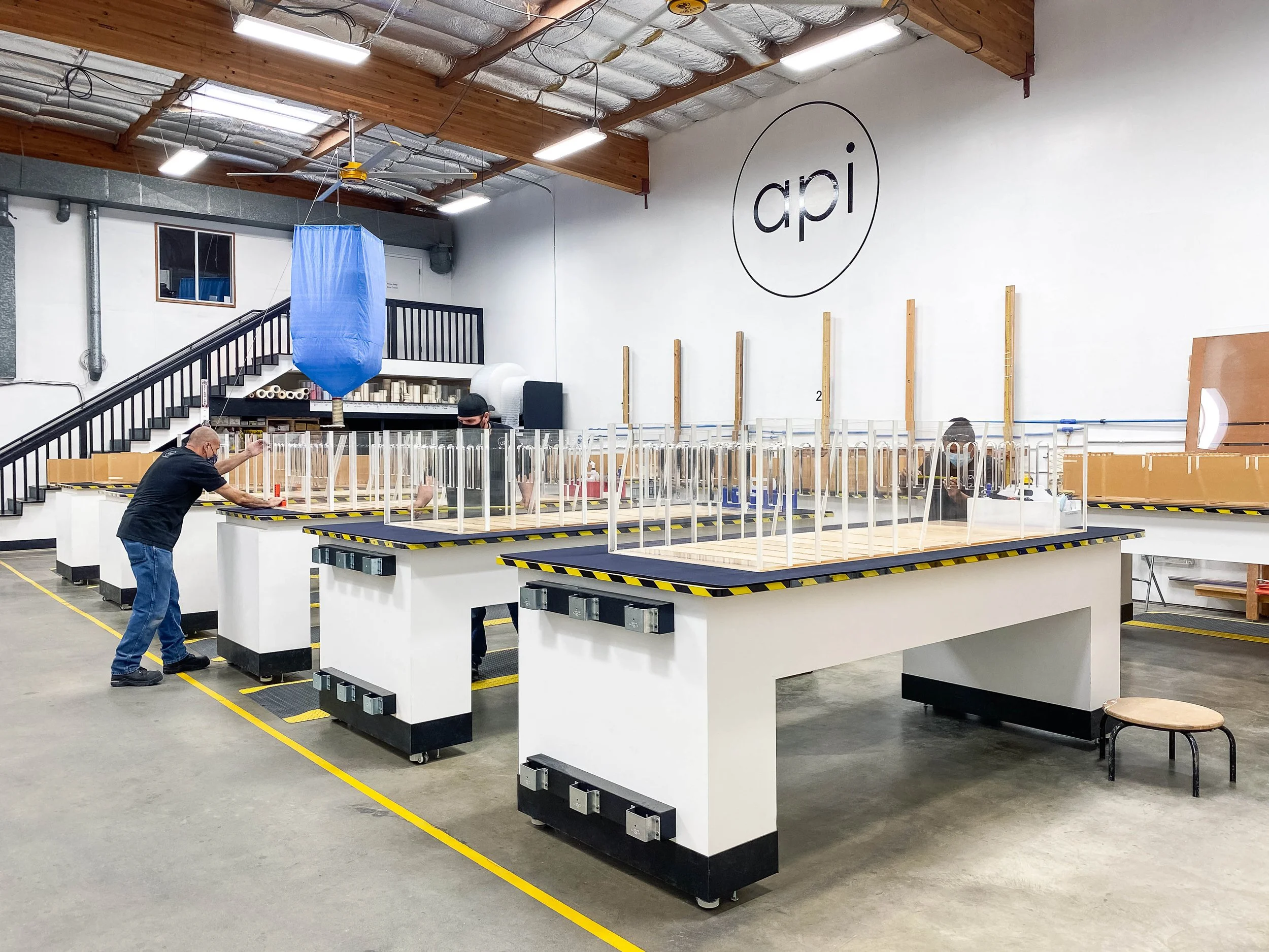 Clear acrylic structural units and assembled on production tables for repeatable alignment and strength.