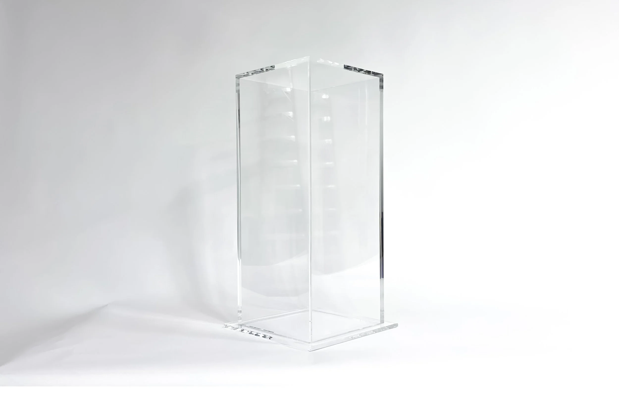 Bonded clear acrylic plinth with a sublte flange on the bottom.