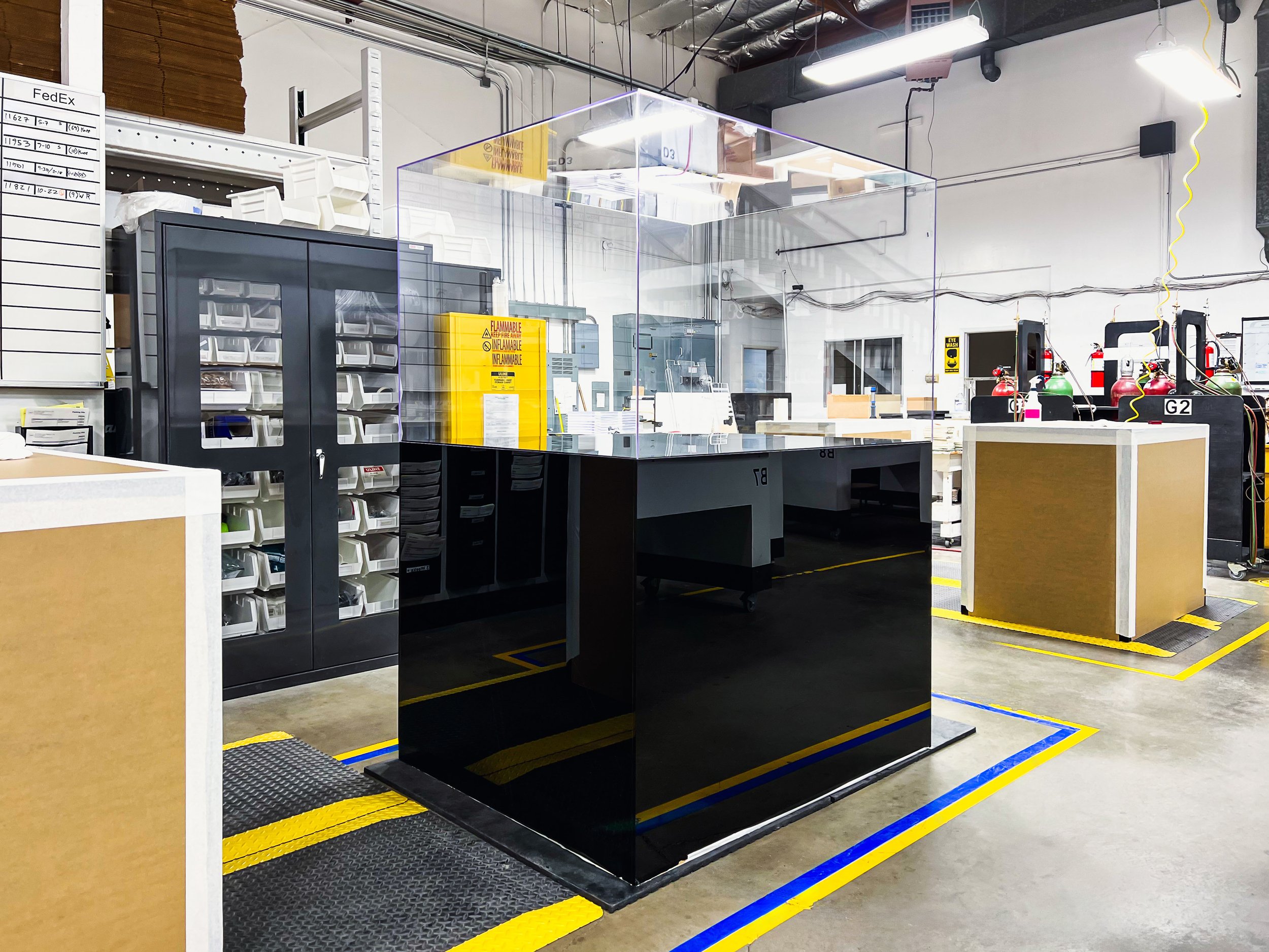 Tru Vue Optium Museum Acrylic display case on a gloss black acrylic pedestal base, built for high-end object display.