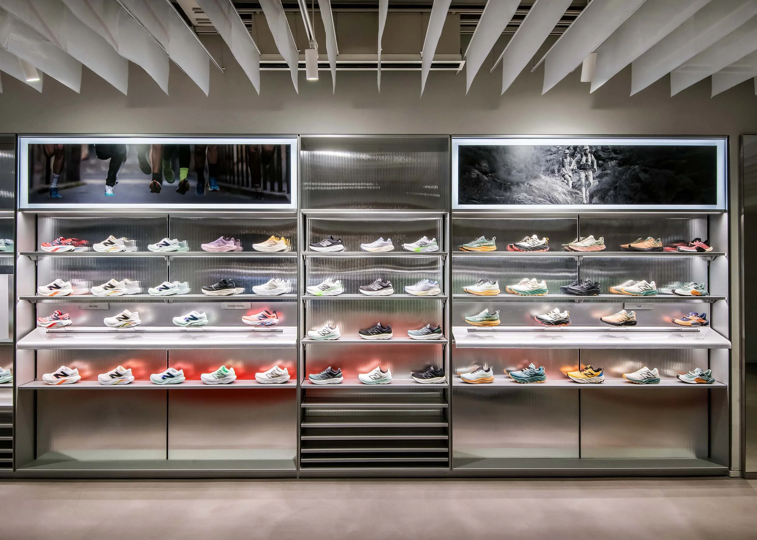 A led lit, aluminium, steel and acrylic display wall for sneakers at New Balance's London flagship store.