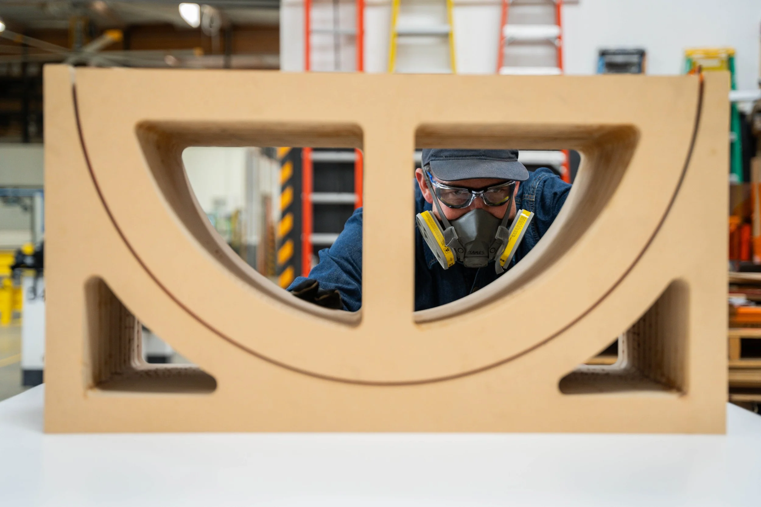 Heated acrylic panel in an MDF form during thermoforming process.  It will cool in this form and then retain its curvature.