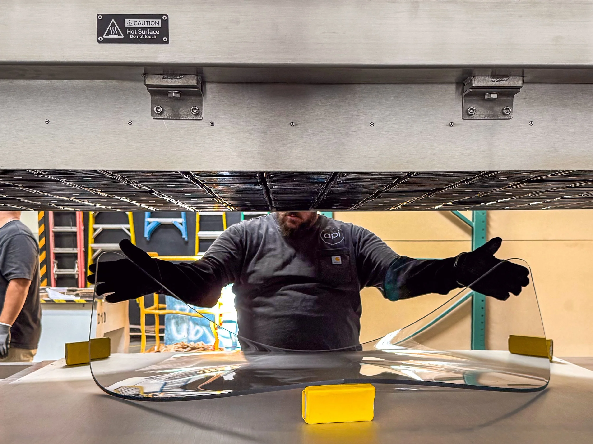 Fabricator in the process of thermoforming a large polycarbonate aircraft windshield using our oversized infrared thermoforming oven.