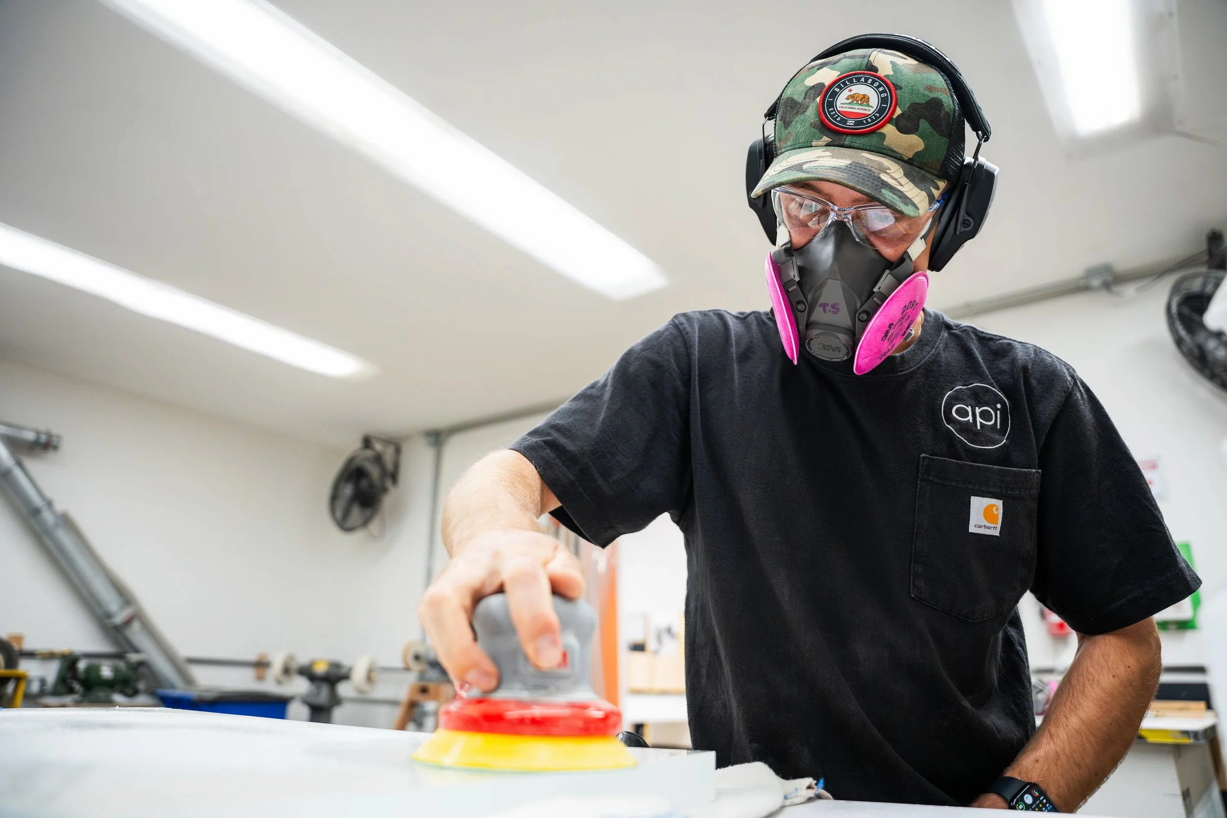 Fabricator buff polishing a clear acrylic slab surface.