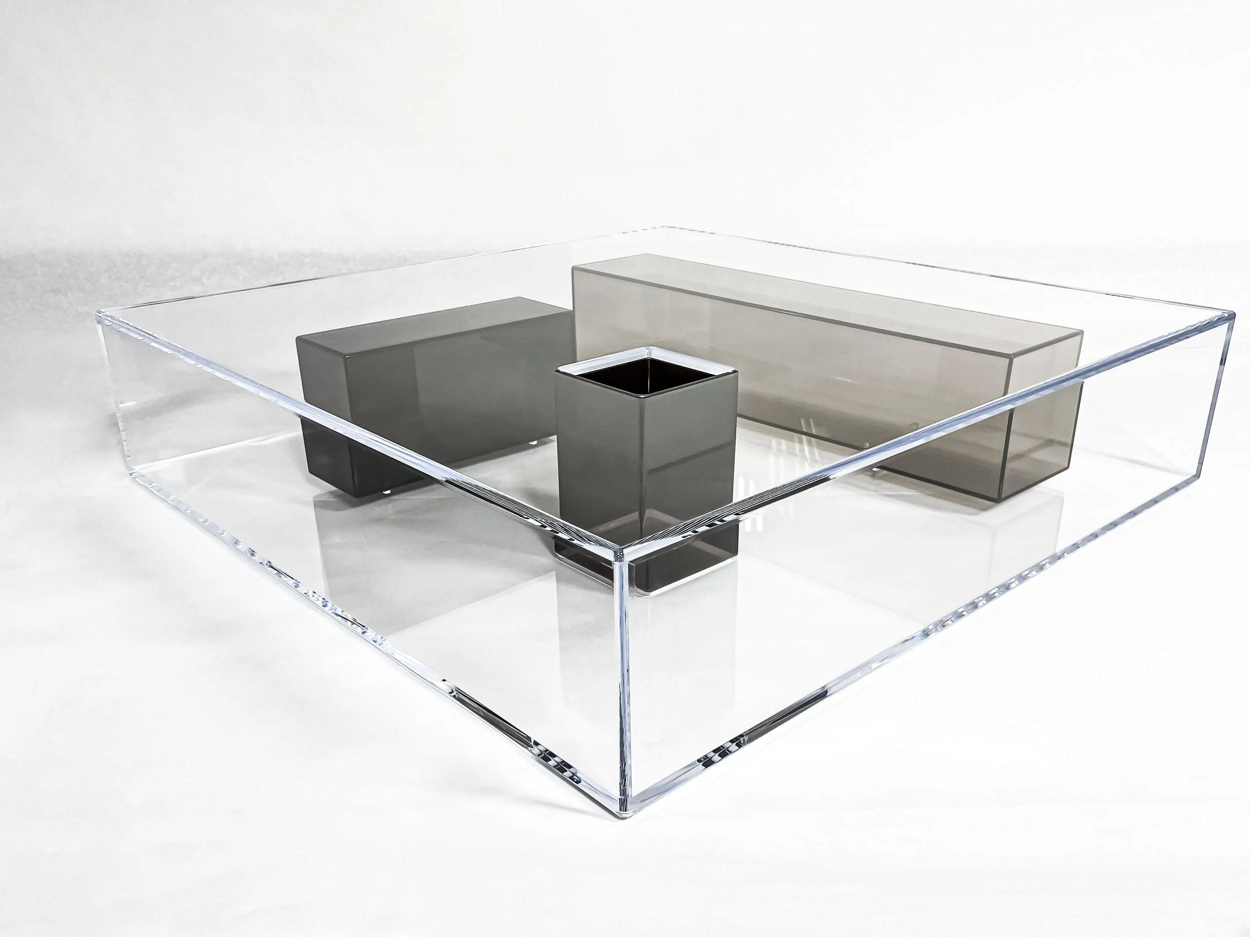 Abstract clear acrylic coffee table with smoke grey acrylic boxes glued inside.