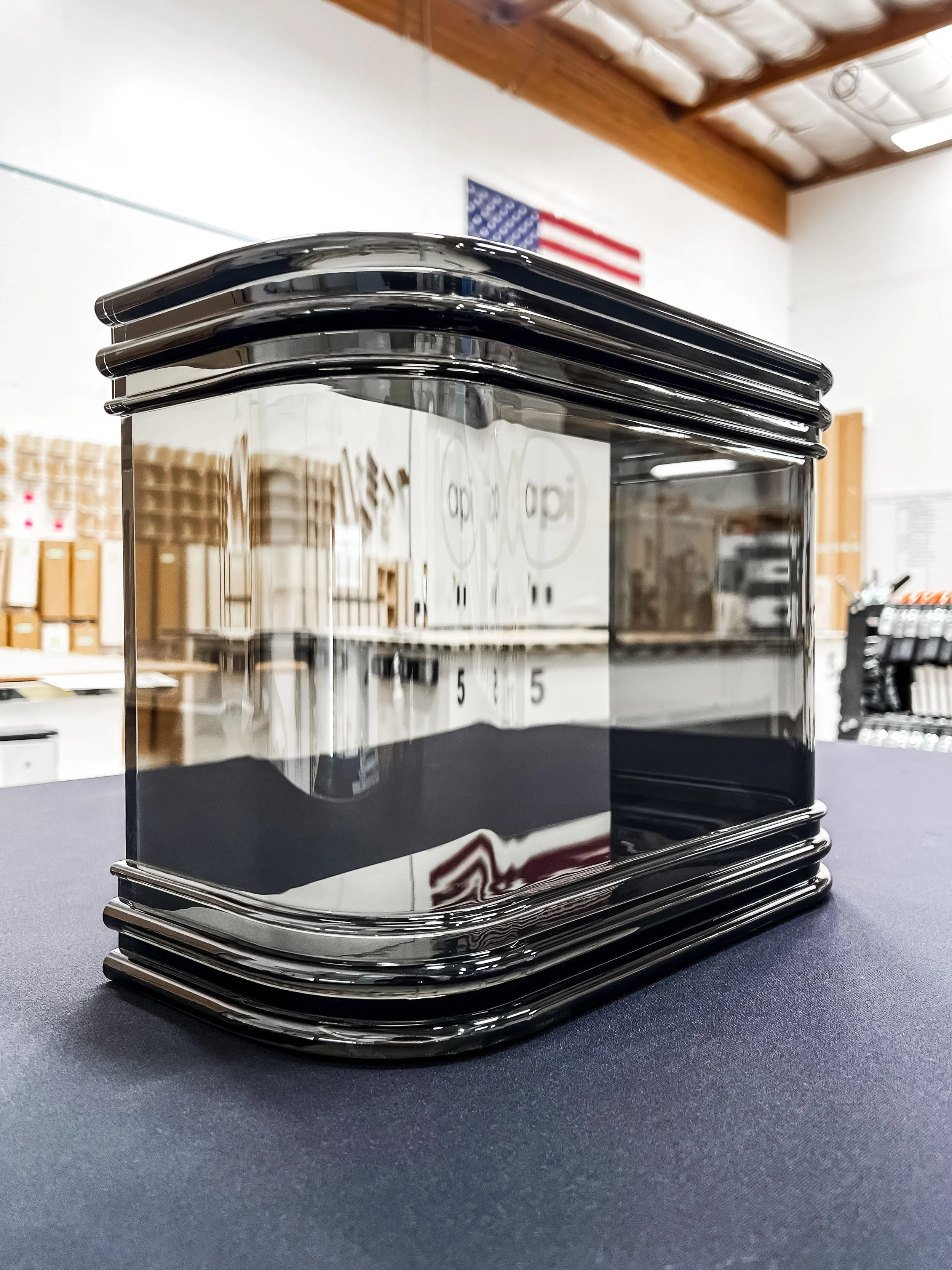 Smoked acrylic thermoformed into a display with ribbed smoked acrylic detailing laminated to it top and bottom.