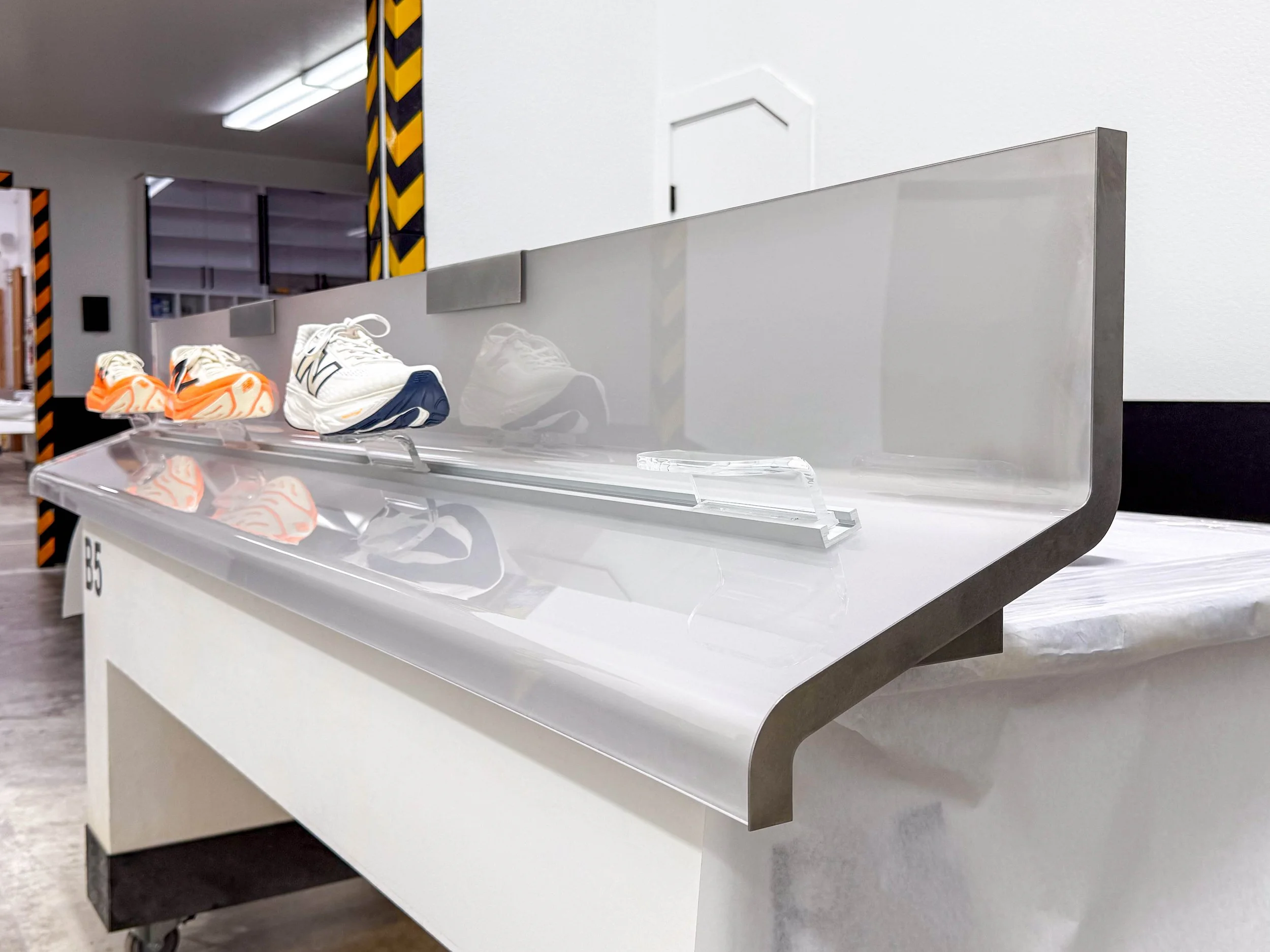 Thermoformed acrylic retail display panel with complex curves and smooth formed geometry for product presentation.