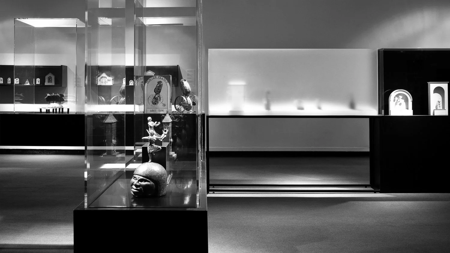 Installed exhibit featuring modular display cases and pedestals built from the design concept.