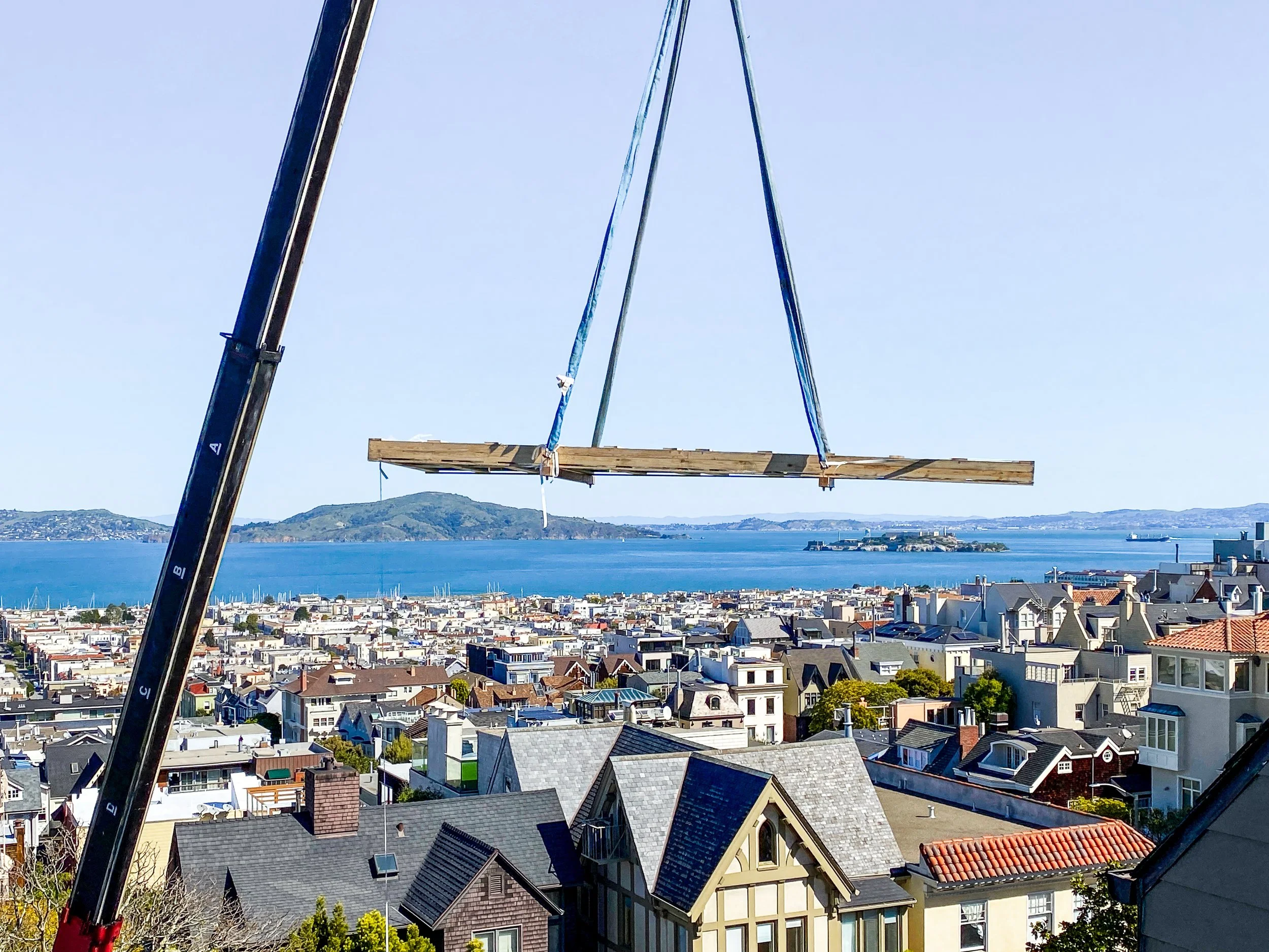 Crane lifting the double seamed Optium Museum Acrylic panel into a private San Francisco, CA residence.