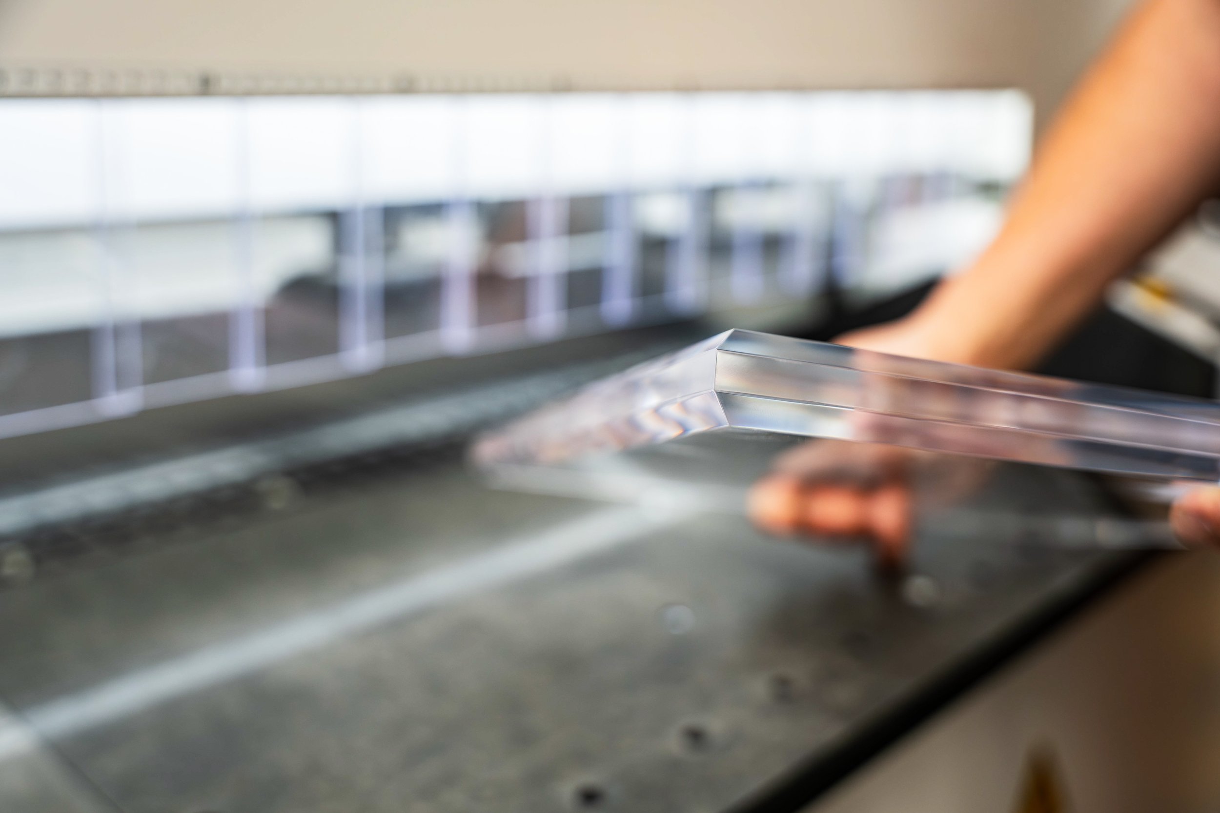 Clear acrylic panel with polished bevel detailing put on by automated edge polishing machine.