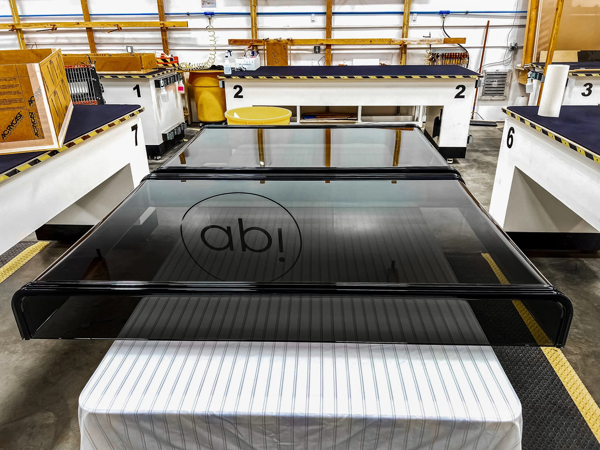 Two large smoked acrylic displays with ribbed smoked acrylic detailing and thermoformed sides.