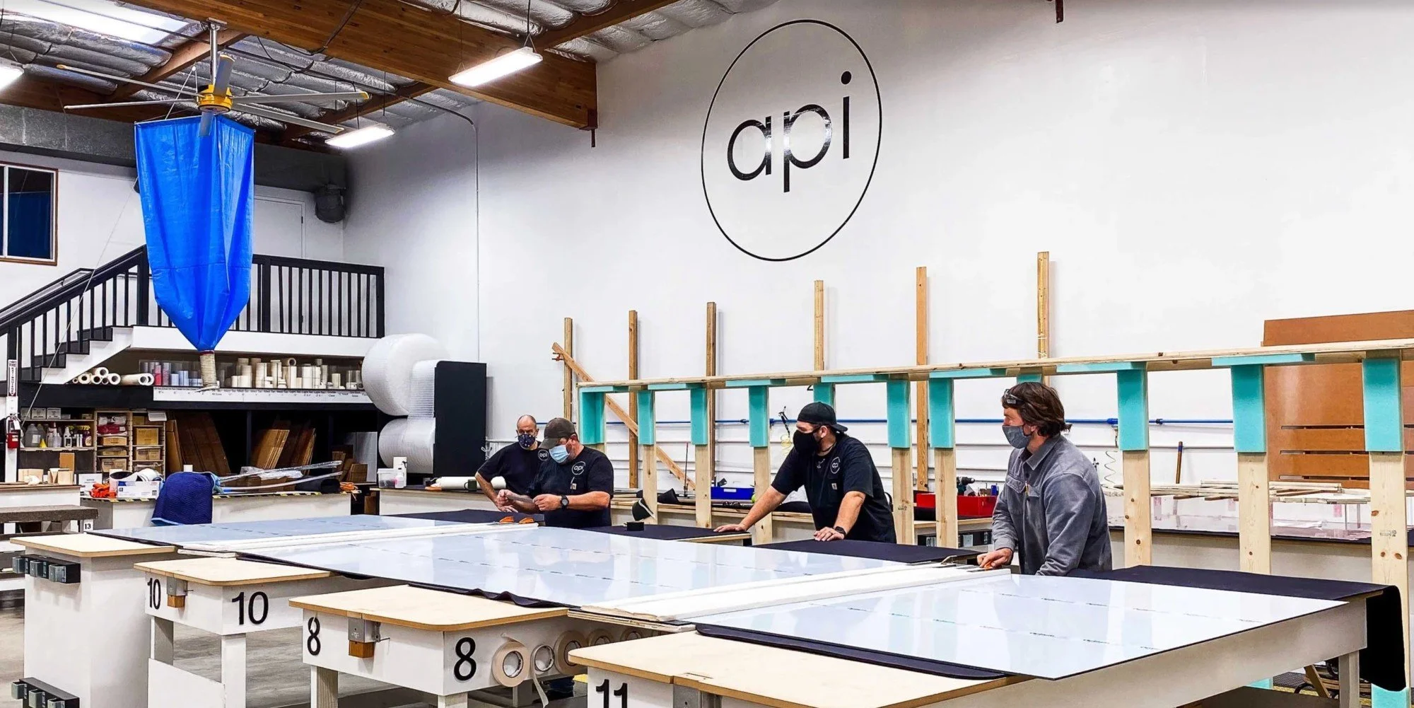 Acrylic fabricators in a production facility in Petaluma, CA doing final quality control check on a double seamed Tru Vue Optium Museum Acrylic panel.