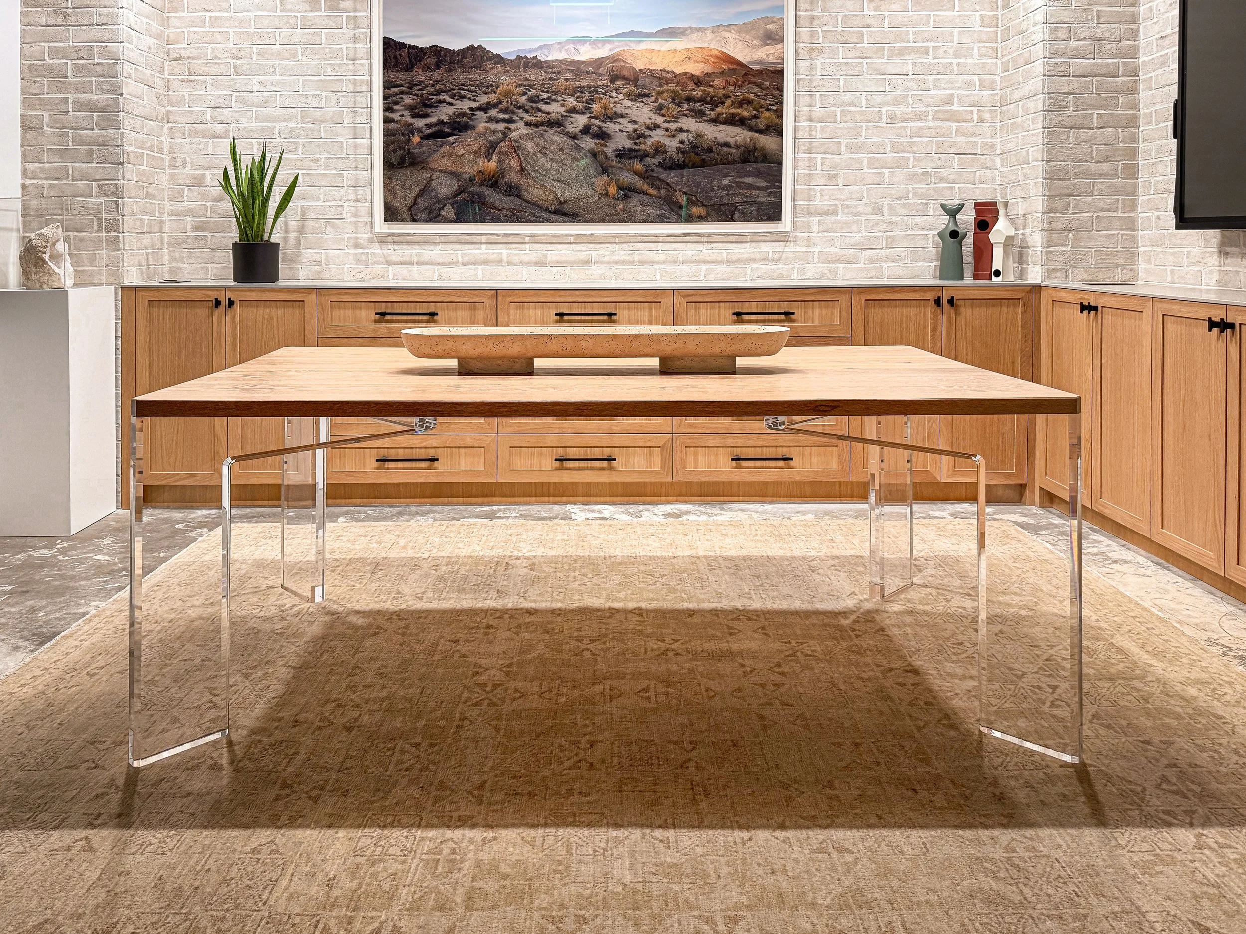Custom dining table with 2 inch thick acrylic legs and white oak wood top built to spec for a residential interior design-forward table and cabinetry installation.
