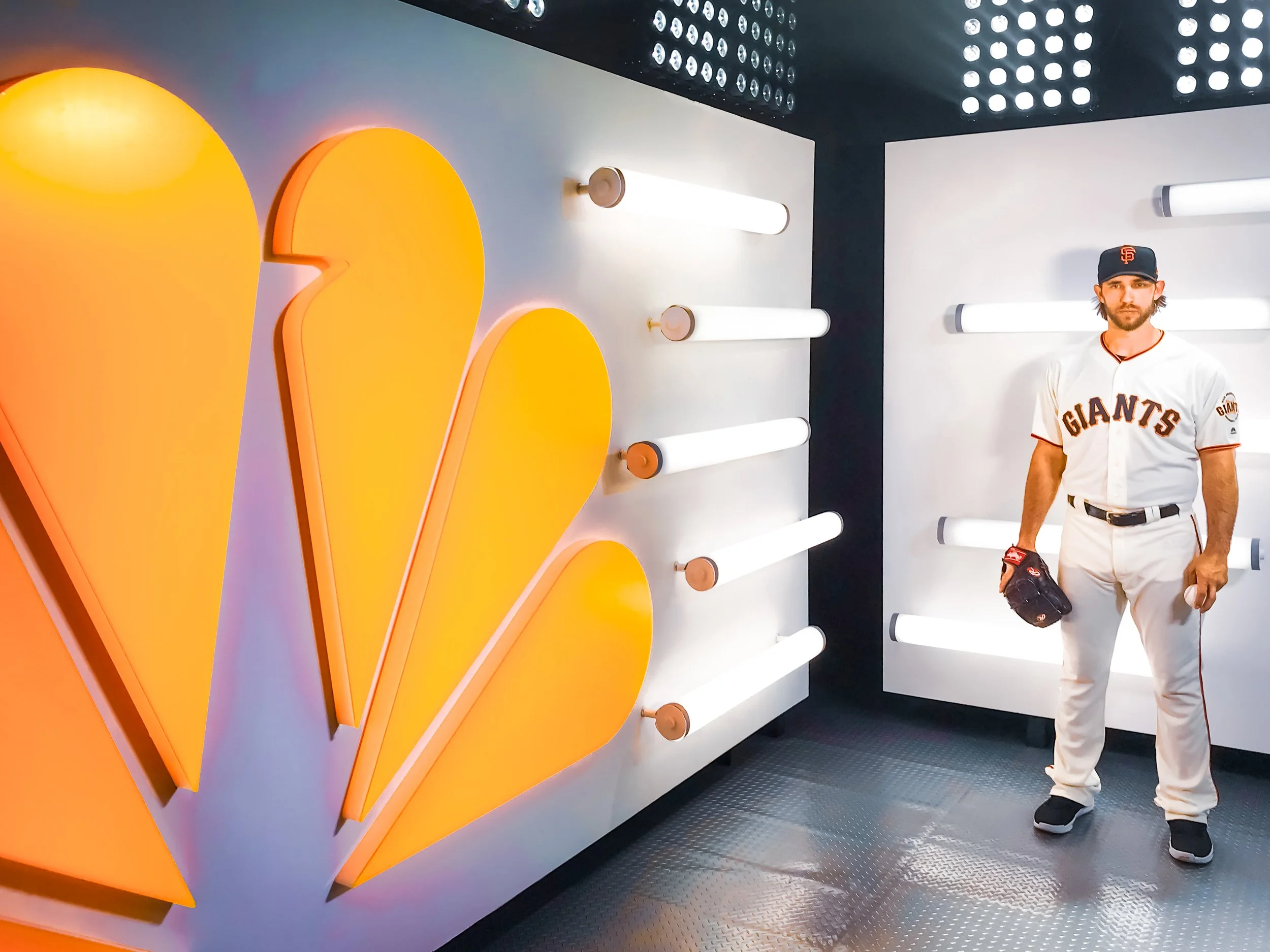 Lit up translucent orange acrylic signage as well as white acrylic tube lights for the Giants photoshoot.