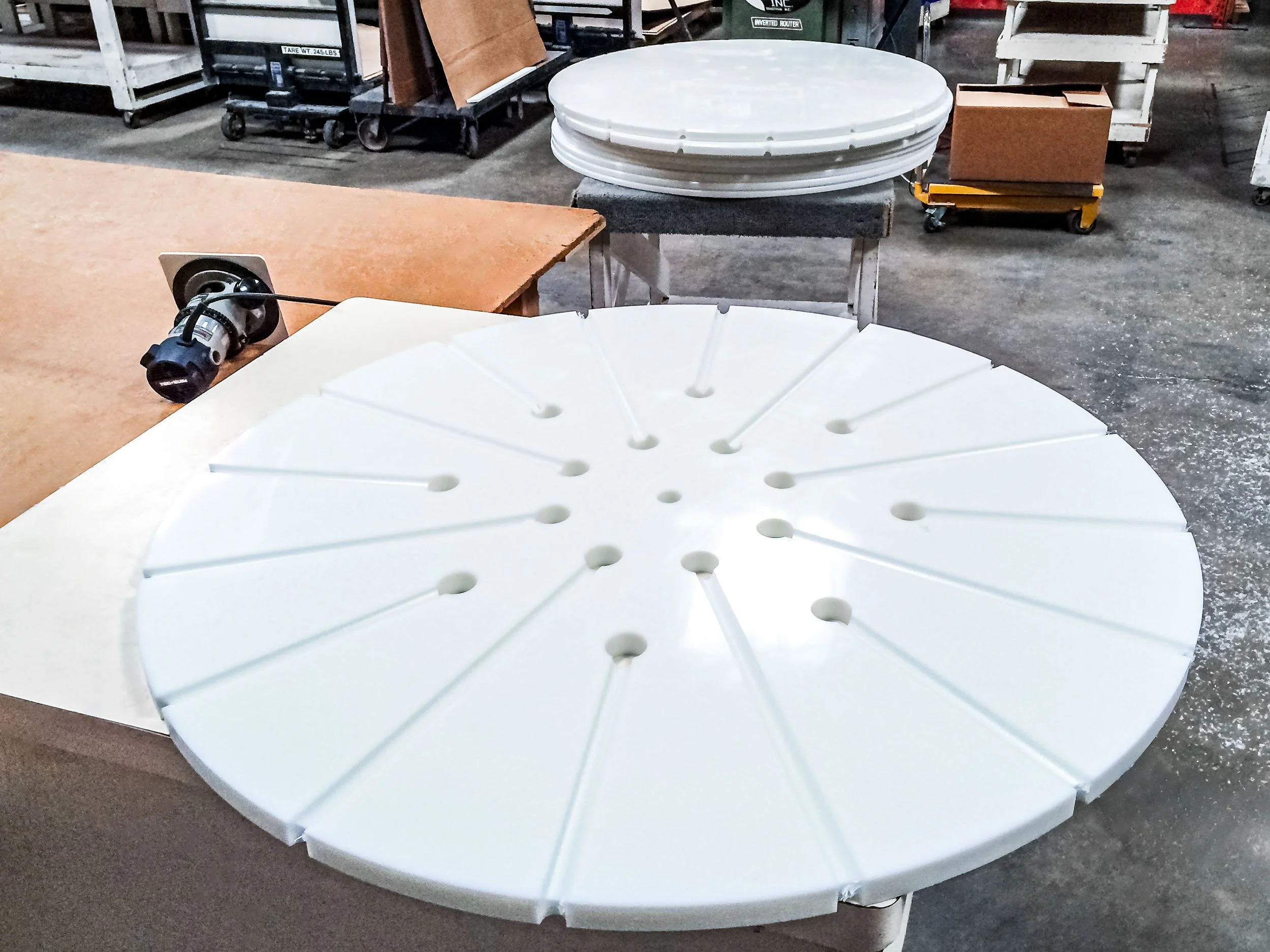 Machined plastic component with patterned grooves and holes for an industrial application.