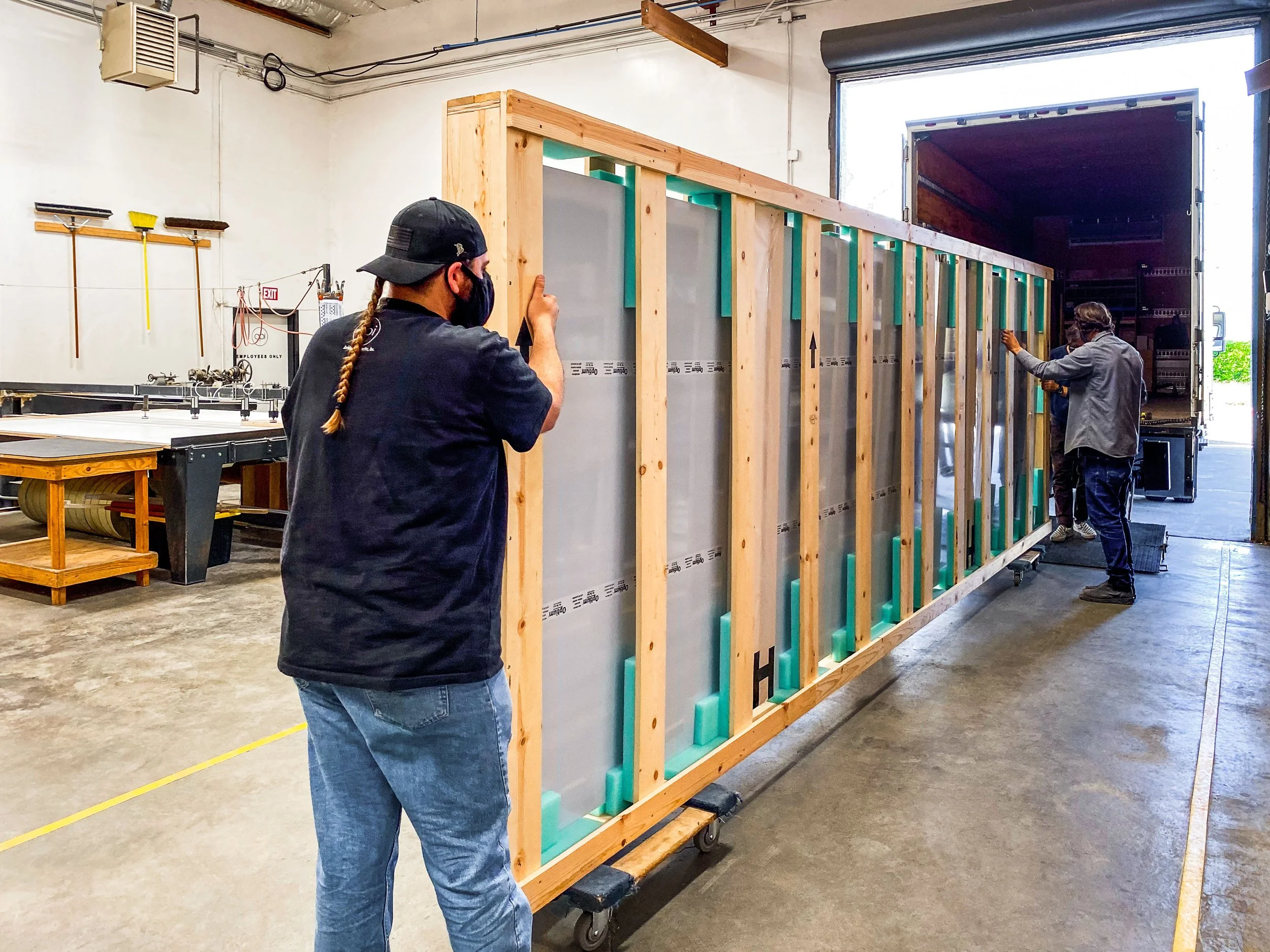 Our fabricators loading a double seamed Optium Museum Acrylic panel onto our box truck for delivery at our Petaluma, CA facility.