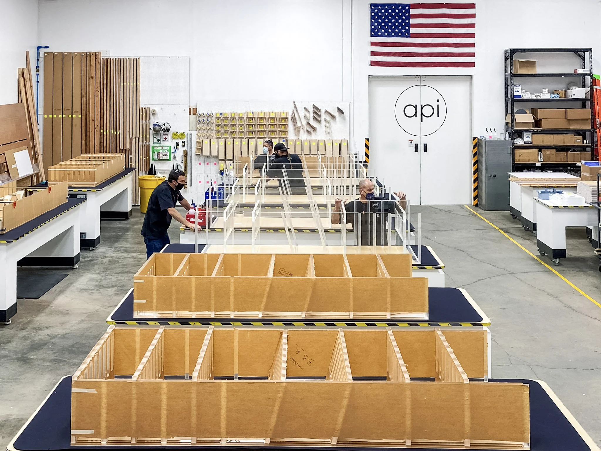 Fabrication crew assembling acrylic wine racks.