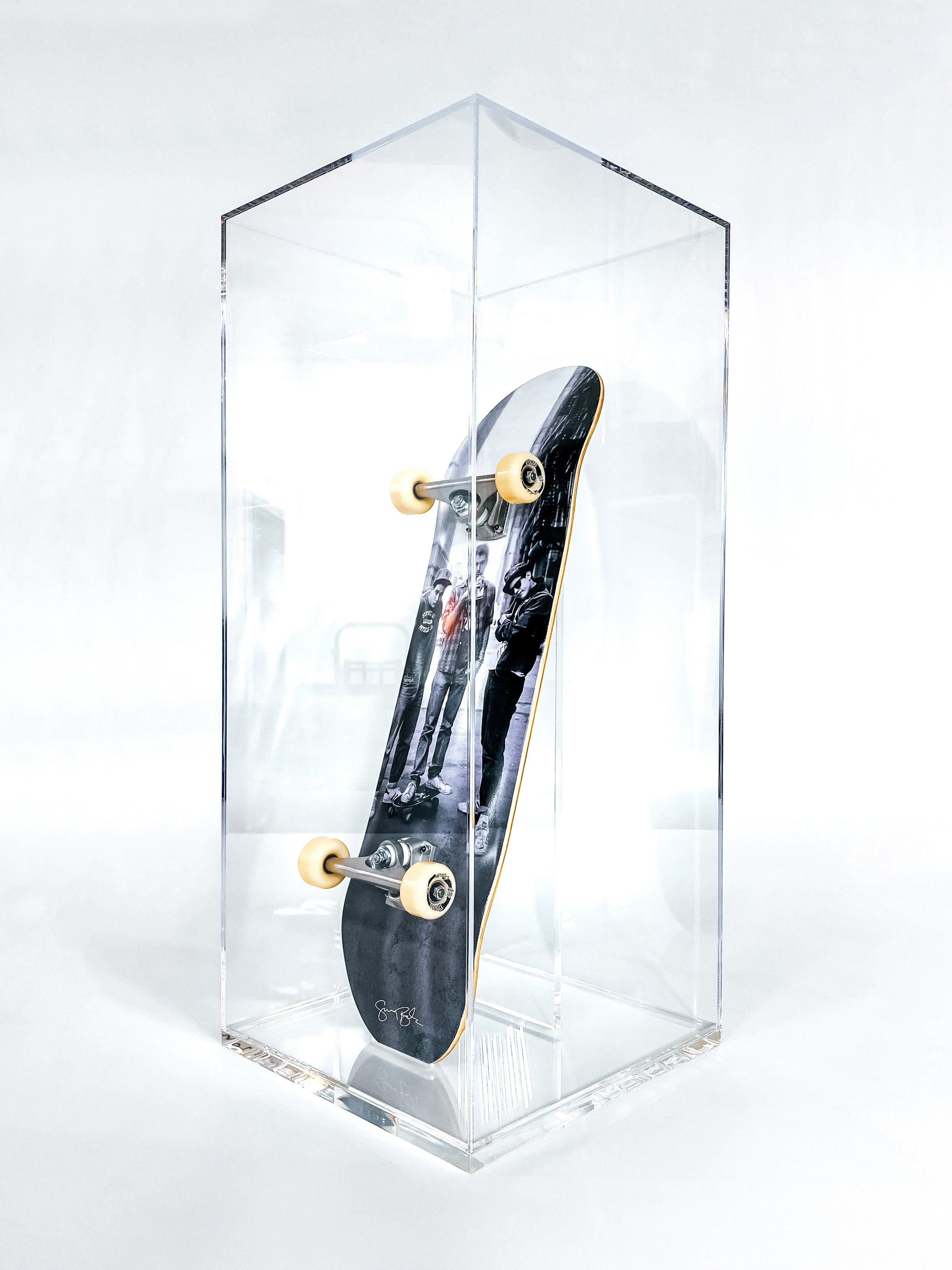 Glued clear acrylic display case with a clear acrylic stand for a skateboard.