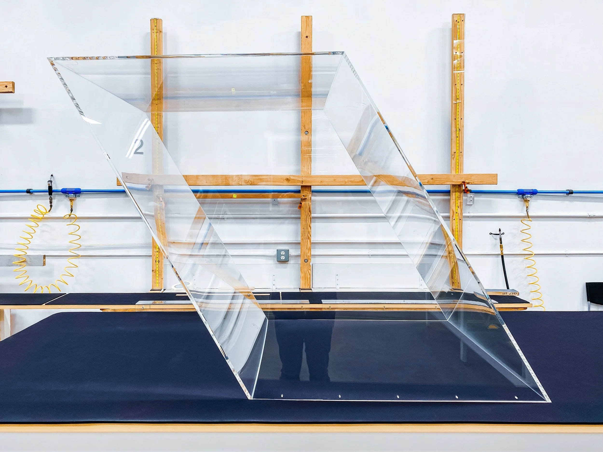 Angled clear acrylic display case with flawless glue seams and holes drilled for attachment to another assembly.