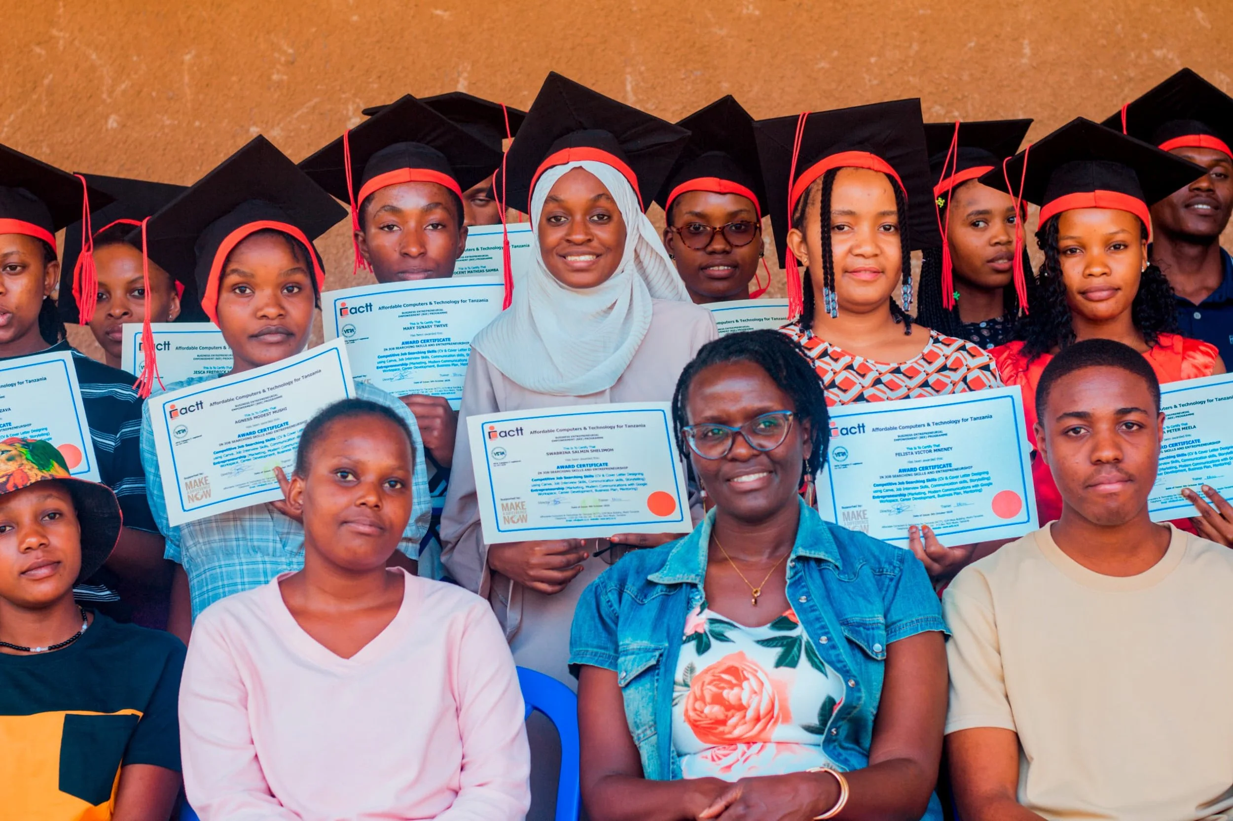 Young women students using laptops in classroom
