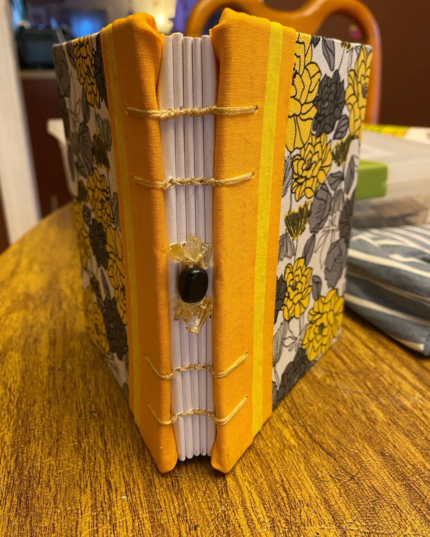 This one is super sunny! Complete with citrine and gold sheen obsidian spine accents. The little stripe happened on its own, and I&rsquo;m kind of in love with the look!

(Image of a book with yellow and gray flowers and a yellow striped eft edge: th